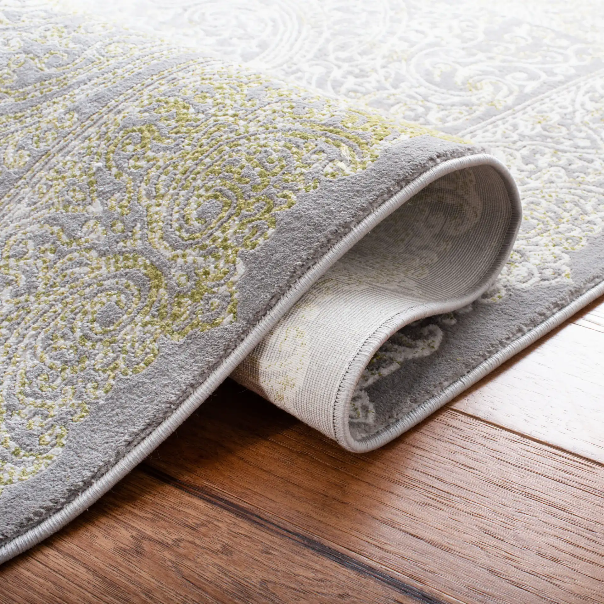 Passion Distressed Scroll Medallion Rug in Gray / Green in a styled room