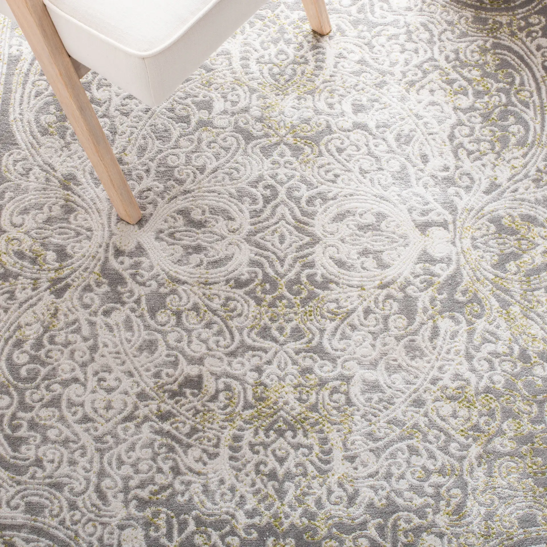 Passion Distressed Scroll Medallion Rug in Gray / Green in a styled room