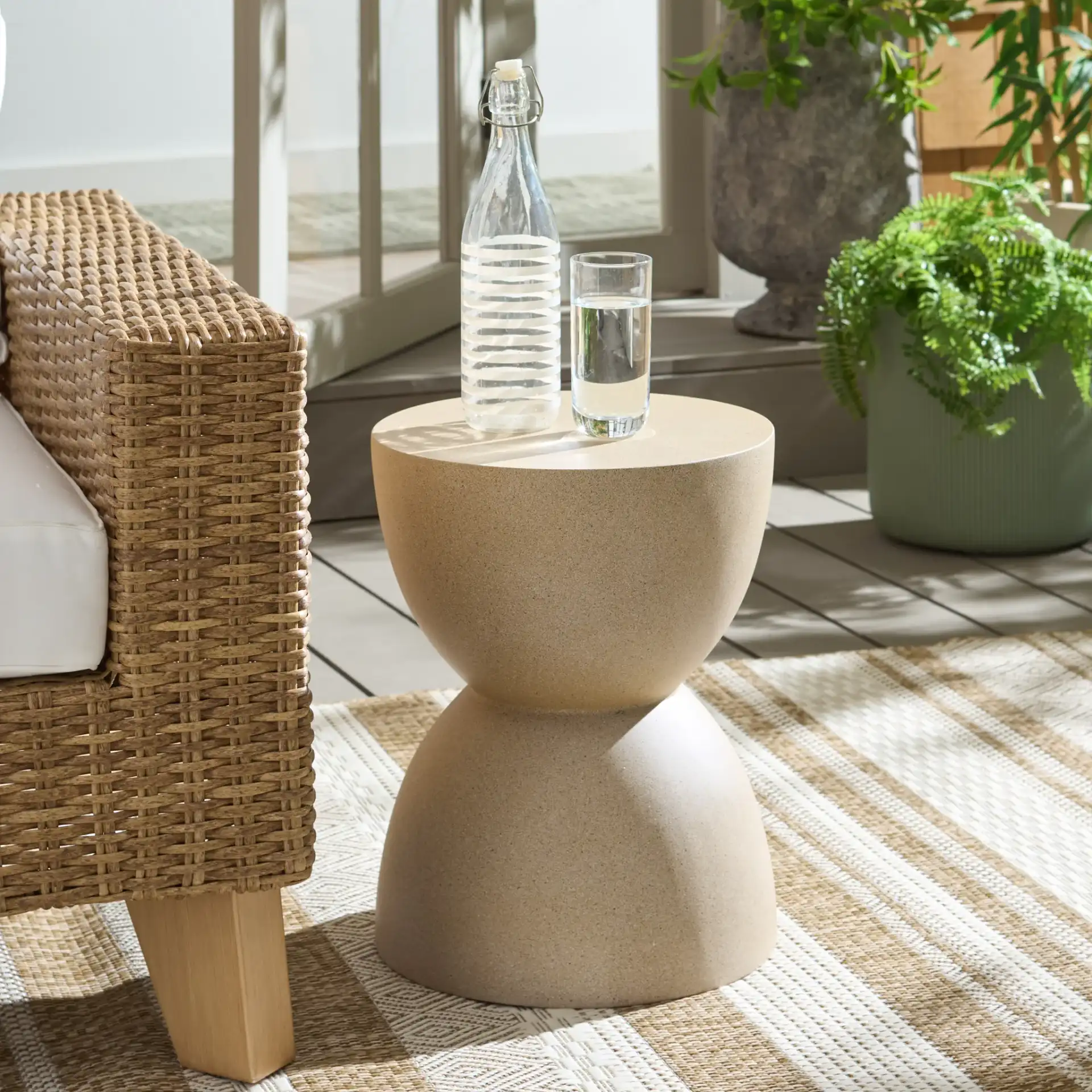 Tina Hourglass Accent Table in Beige in a styled room