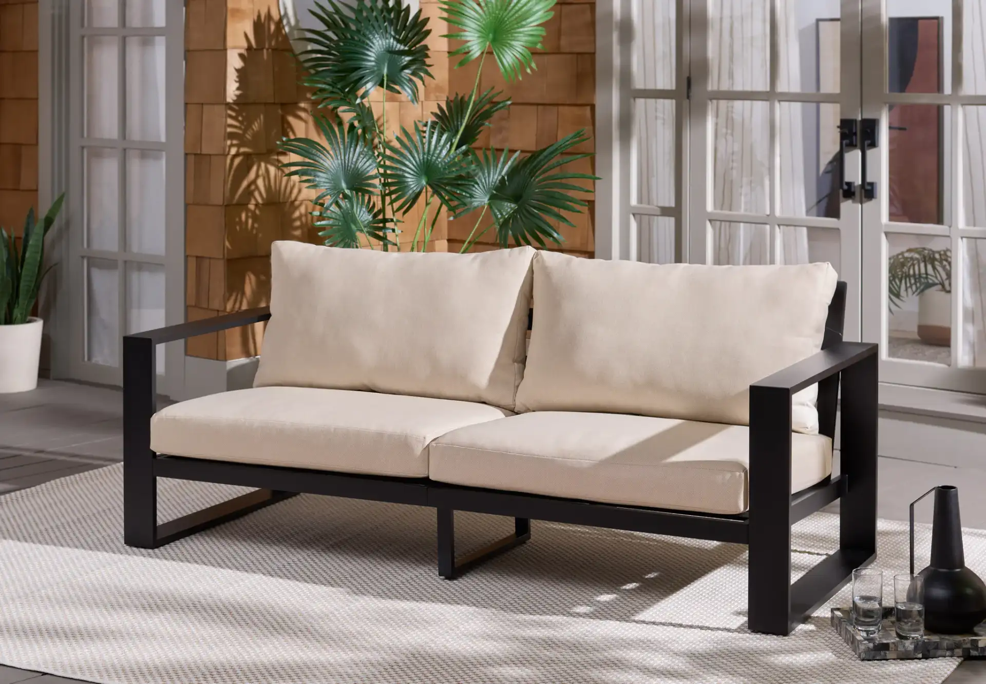 Fash Aluminum Sofa in Black / Taupe in a styled room