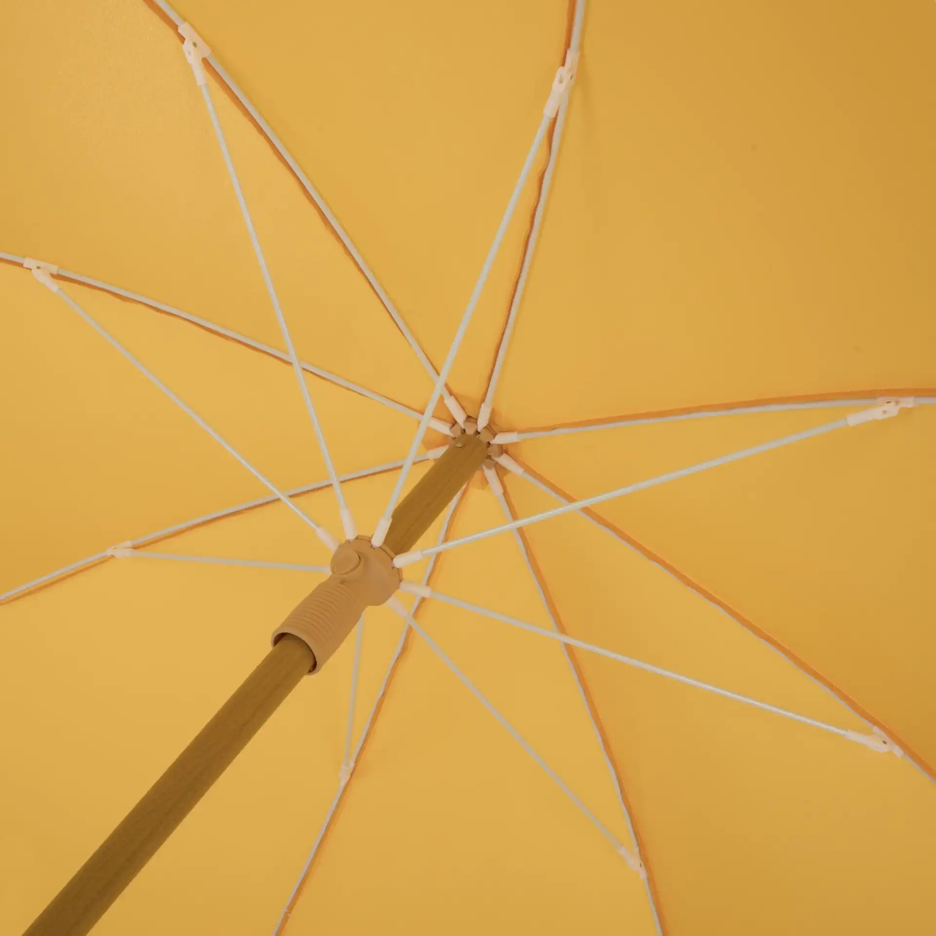 Valencia 6.5-Foot Beach Umbrella in Yellow in a styled room