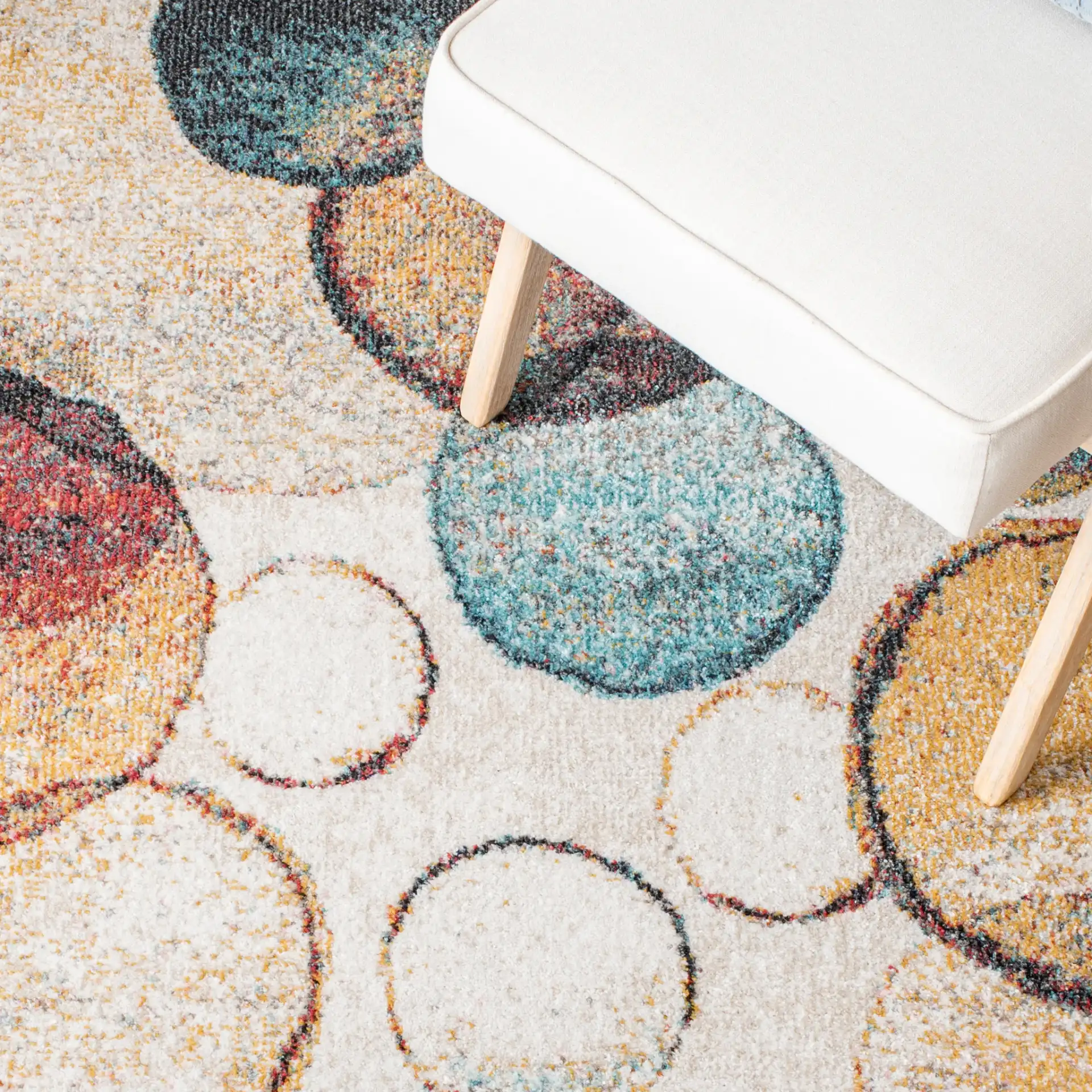 Phoenix Overlapping Circles Rug in Ivory / Rust in a styled room
