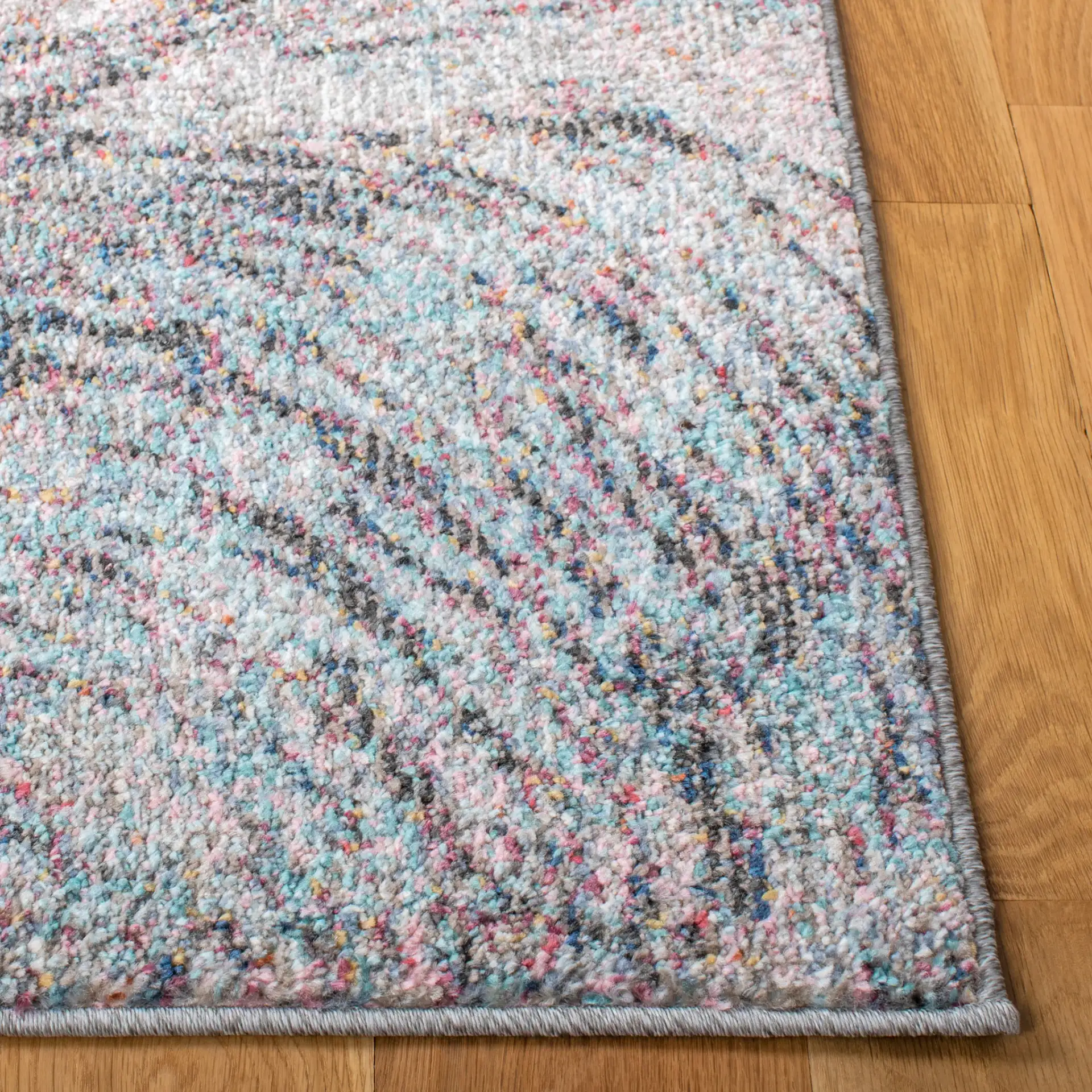Phoenix Swirling Wave Rug in Ivory / Pink in a styled room