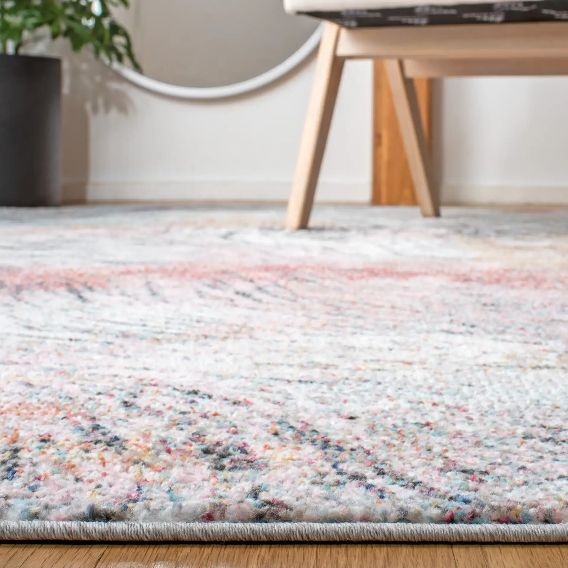 Phoenix Swirling Wave Rug in Ivory / Pink in a styled room