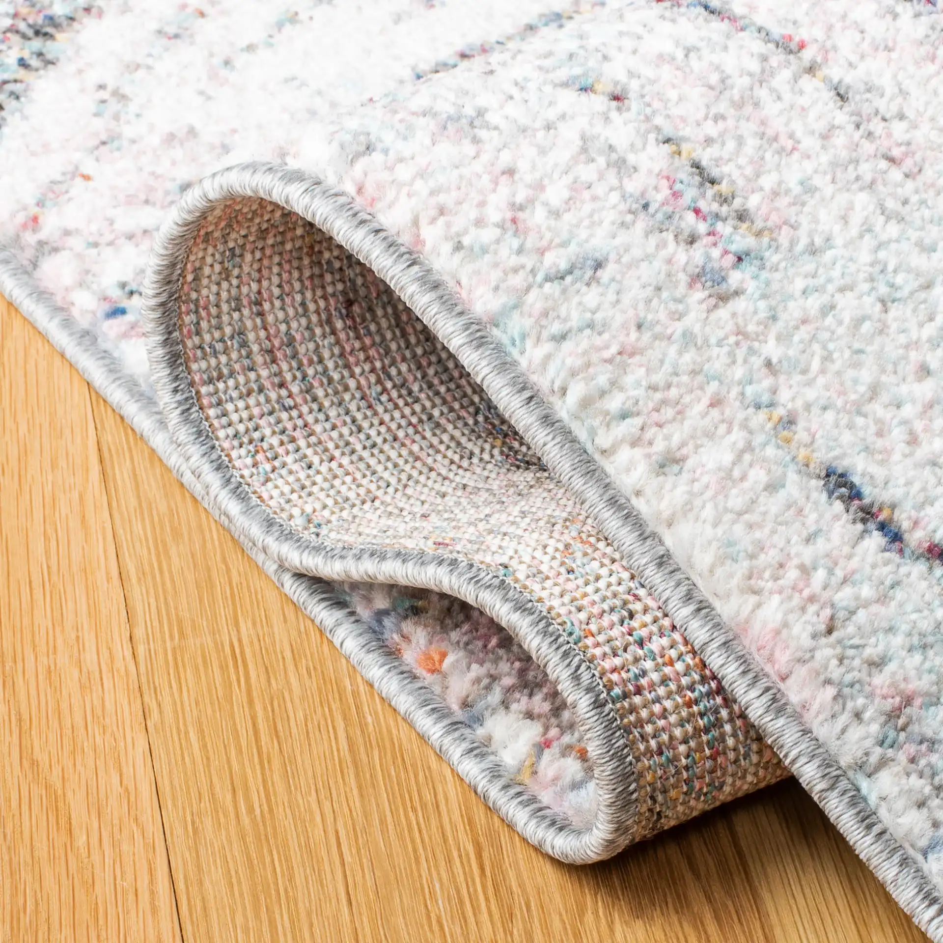 Phoenix Swirling Wave Rug in Ivory / Pink in a styled room