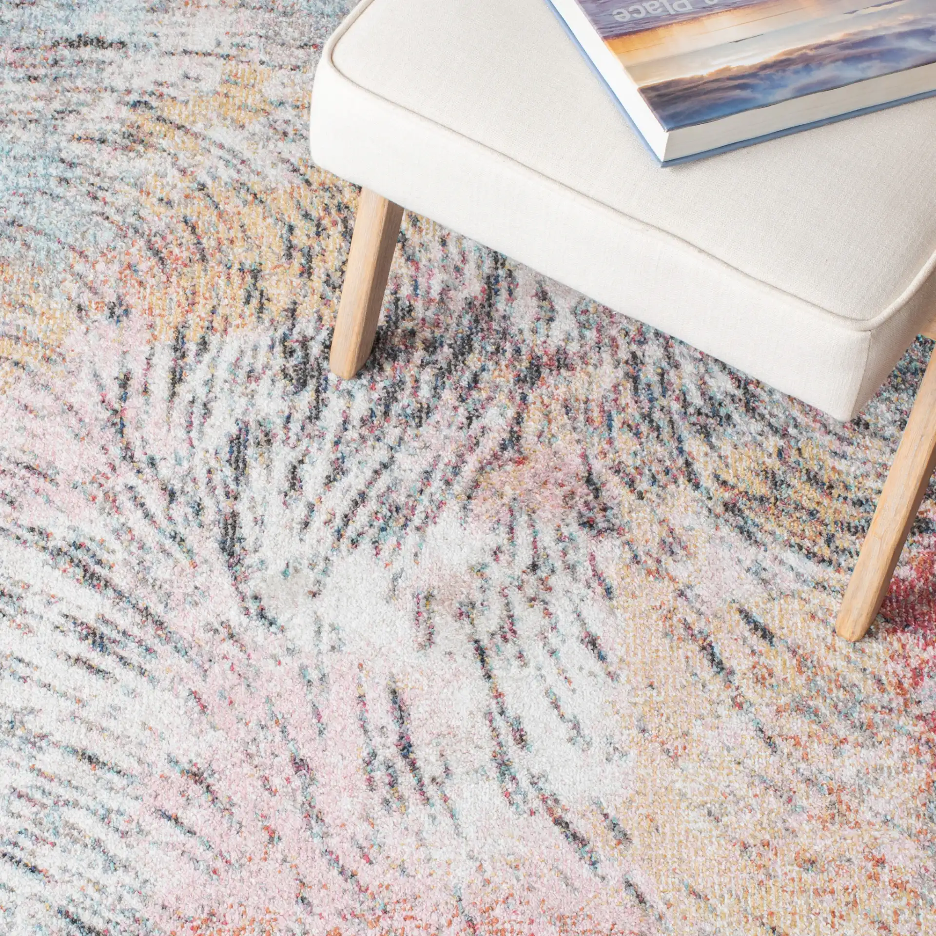 Phoenix Swirling Wave Rug in Ivory / Pink in a styled room