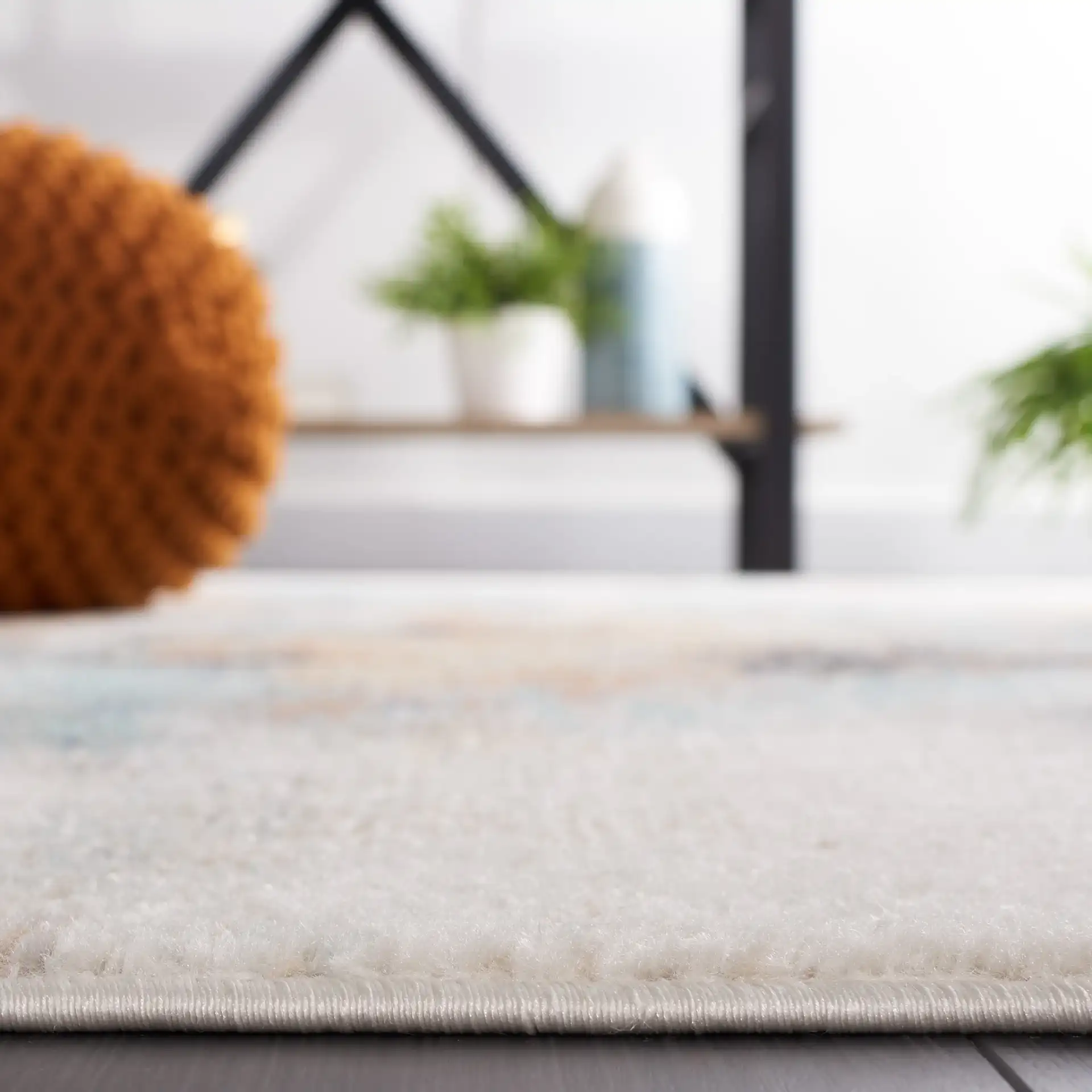 Phoenix Abstract Rug in Aqua / Gold Rust in a styled room