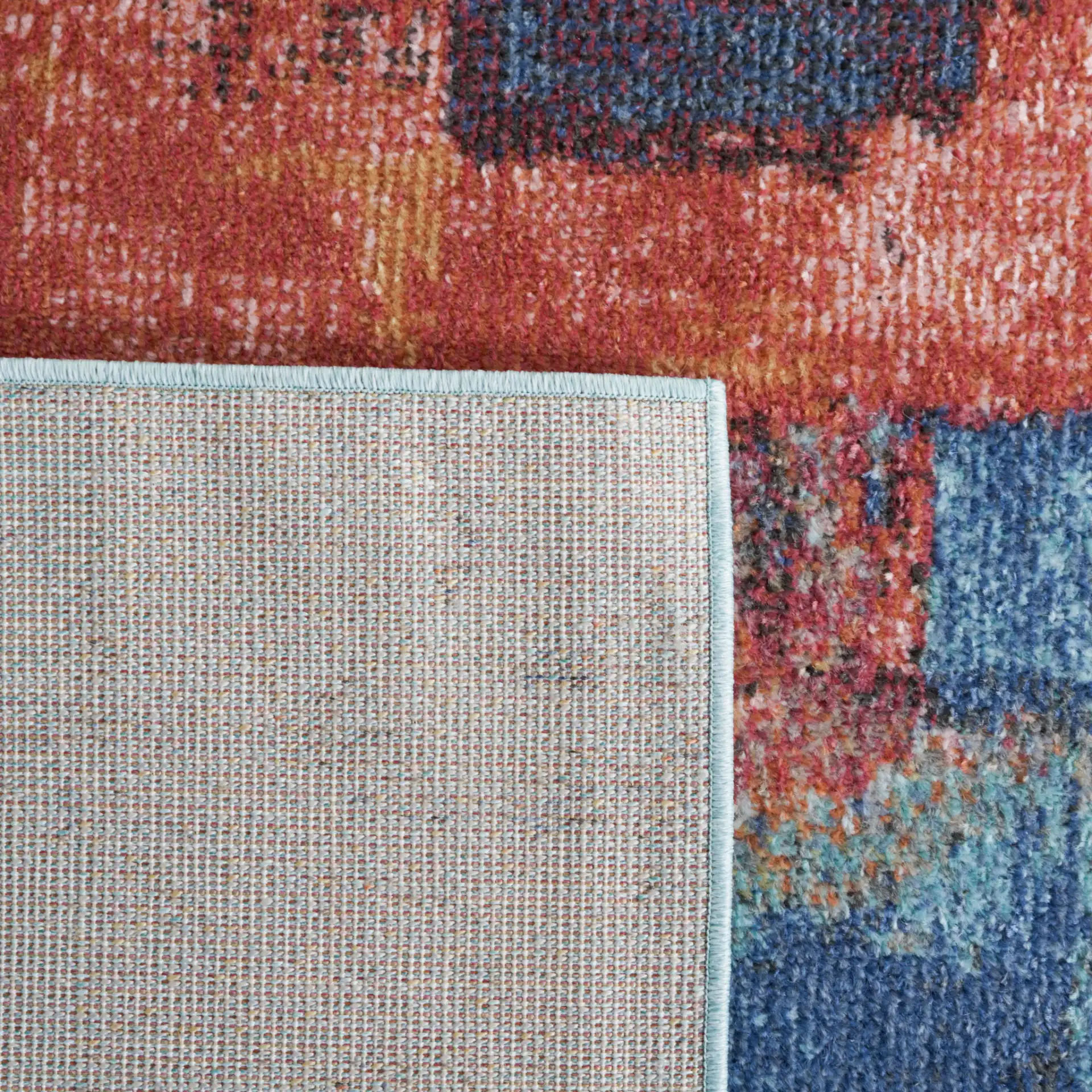 Phoenix Painterly Block Rug in Rust Blue / Ivory in a styled room