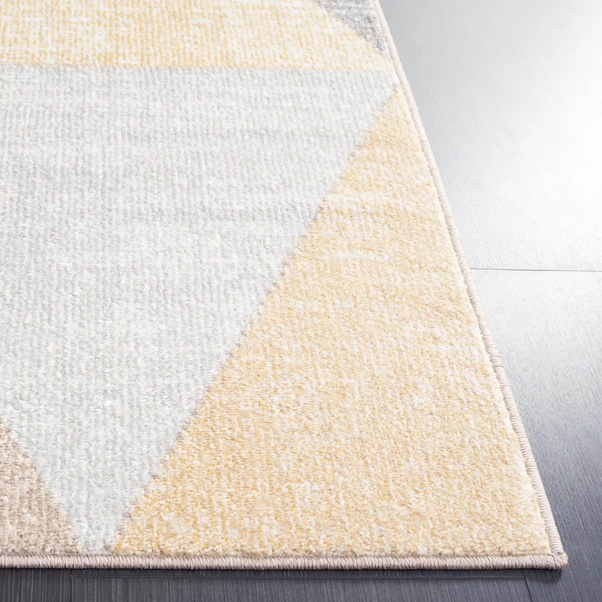 Phoenix Large Triangle Rug in Gray / Rust in a styled room