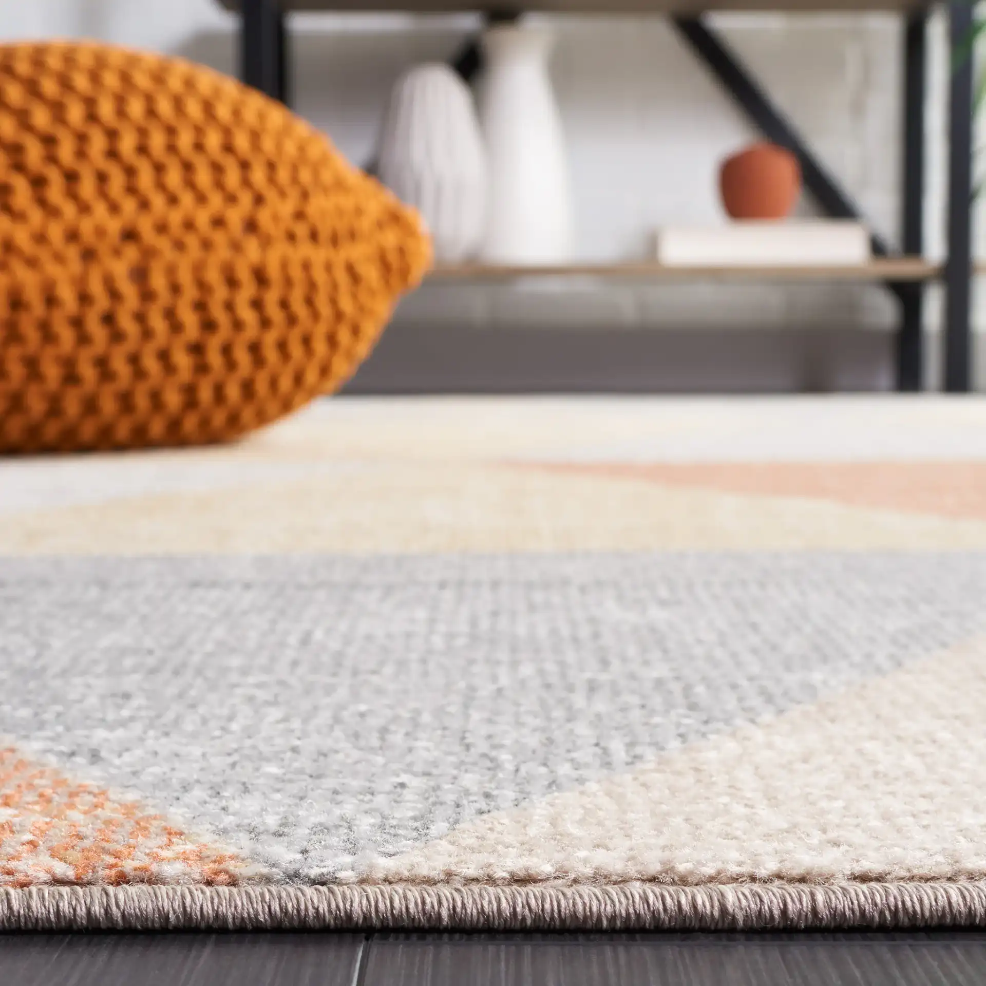 Phoenix Large Triangle Rug in Gray / Rust in a styled room