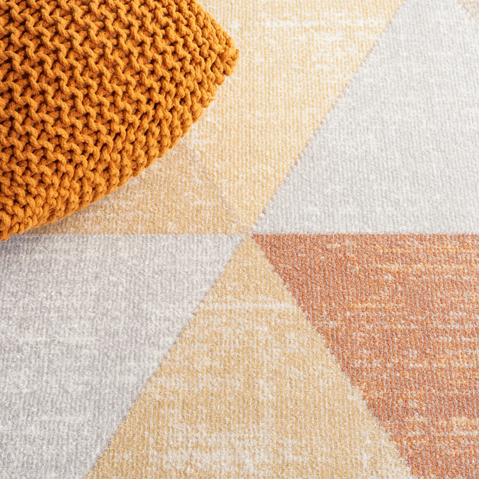 Phoenix Large Triangle Rug in Gray / Rust in a styled room