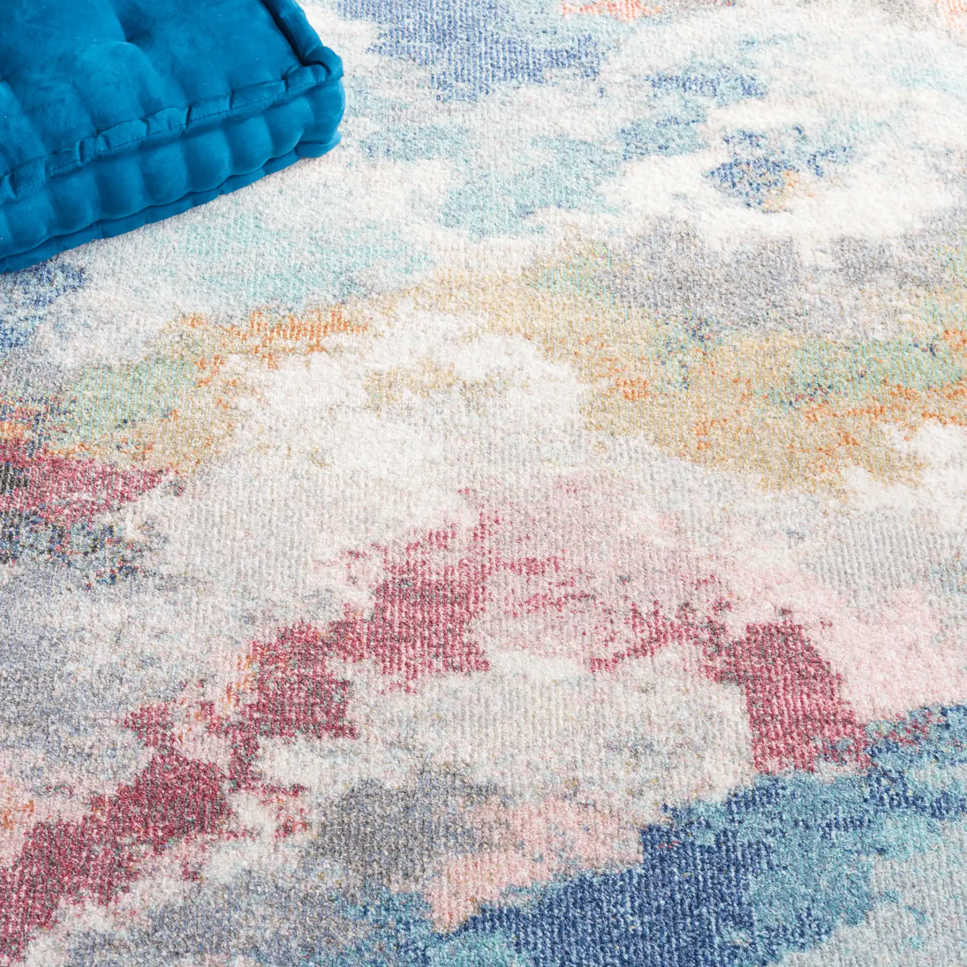 Phoenix Abstract Cloud Rug in Ivory / Blue Rust in a styled room