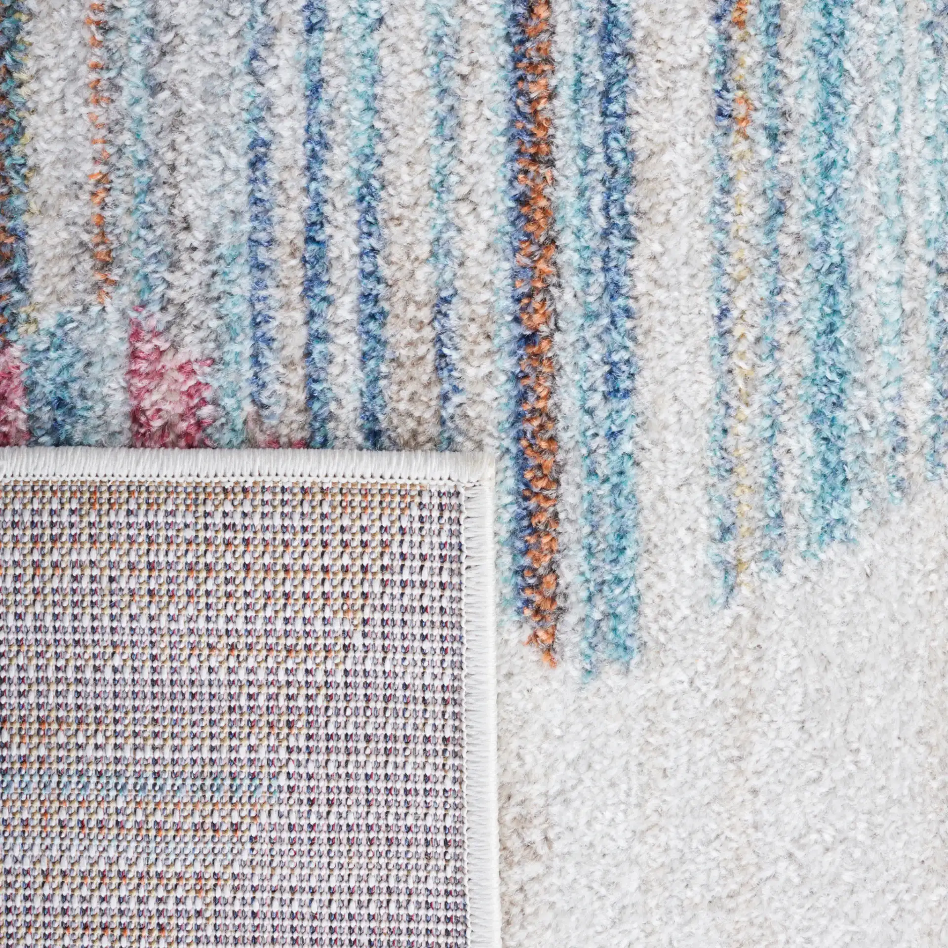 Phoenix Striated Diamond Rug in Ivory / Blue in a styled room