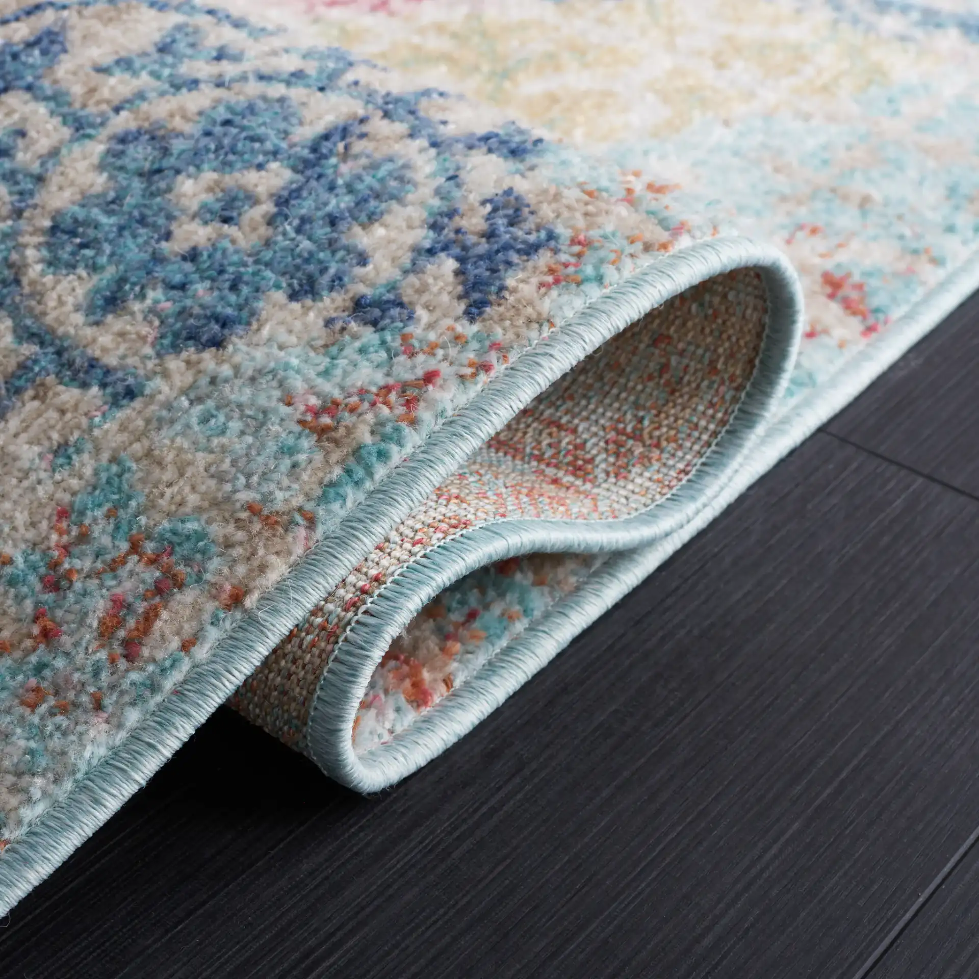 Phoenix Distressed Patchwork Rug in Blue / Rust in a styled room