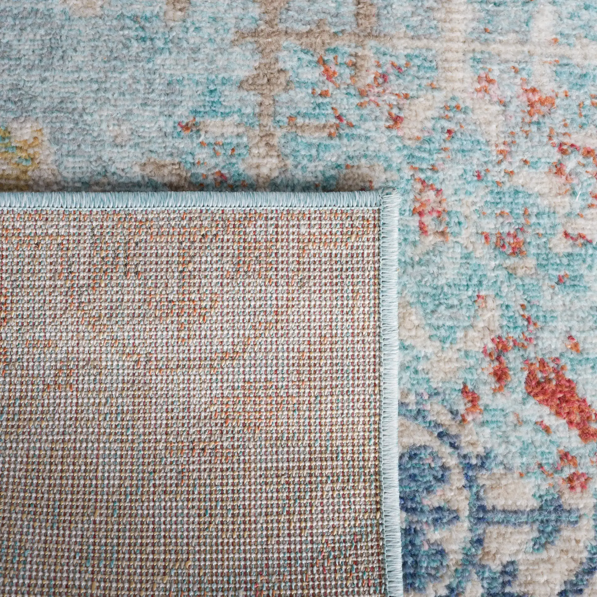 Phoenix Distressed Patchwork Rug in Blue / Rust in a styled room