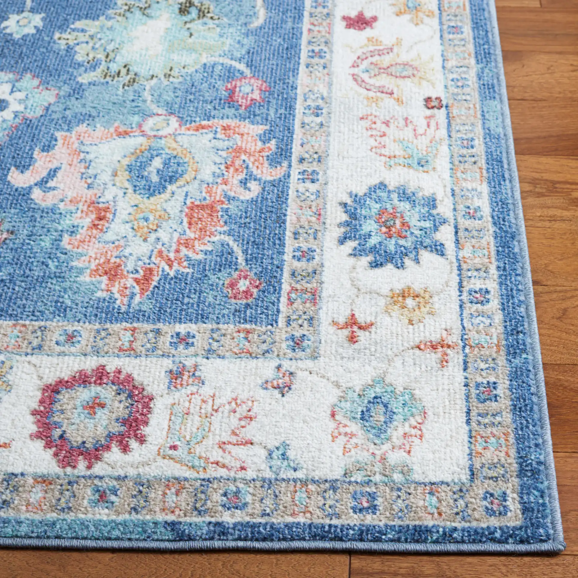 Phoenix Floral Bordered Rug in Navy / Ivory in a styled room