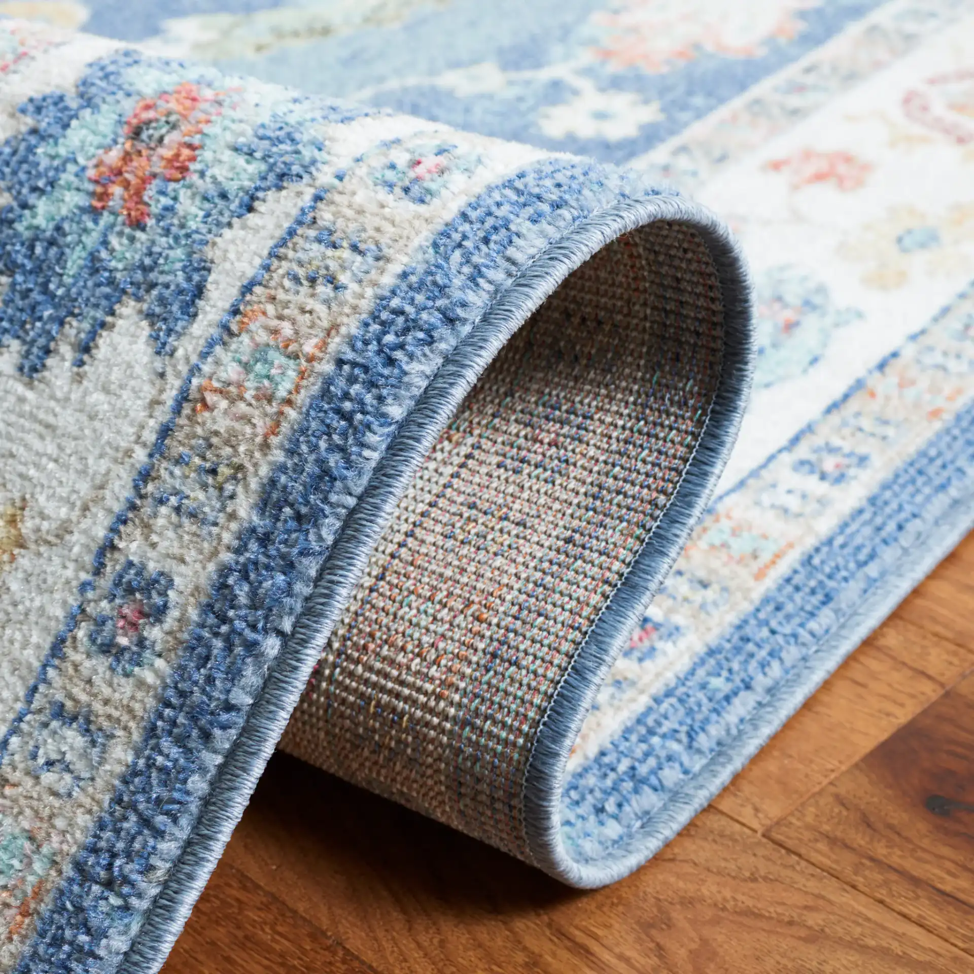 Phoenix Floral Bordered Rug in Navy / Ivory in a styled room