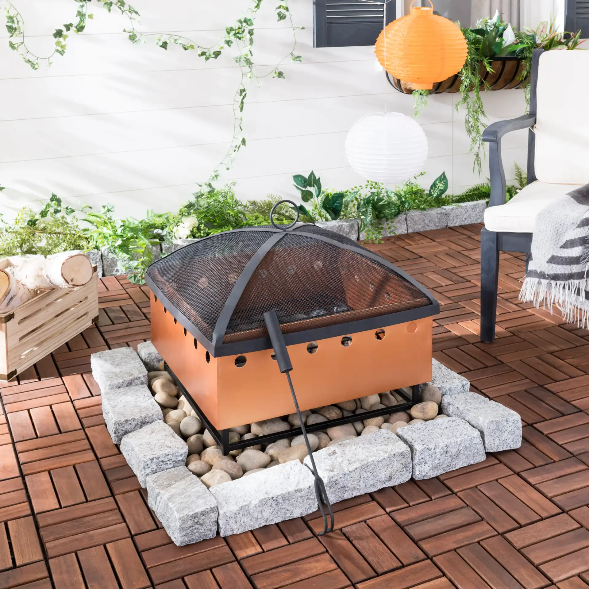 Wyatt Square Fire Pit in Copper / Black in a styled room