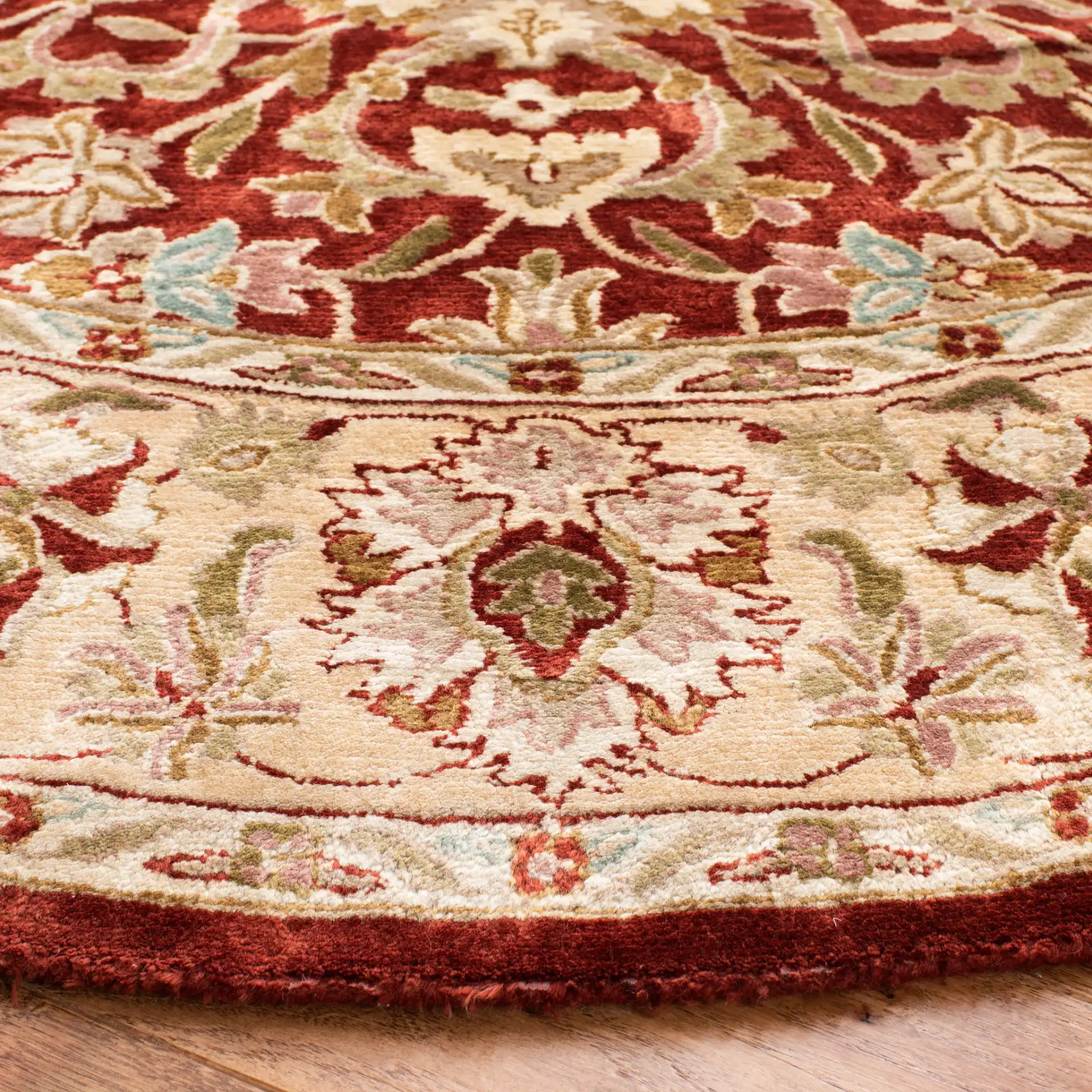 Persian Legend Floral Bordered Oval Wool Rug in Rust in a styled room