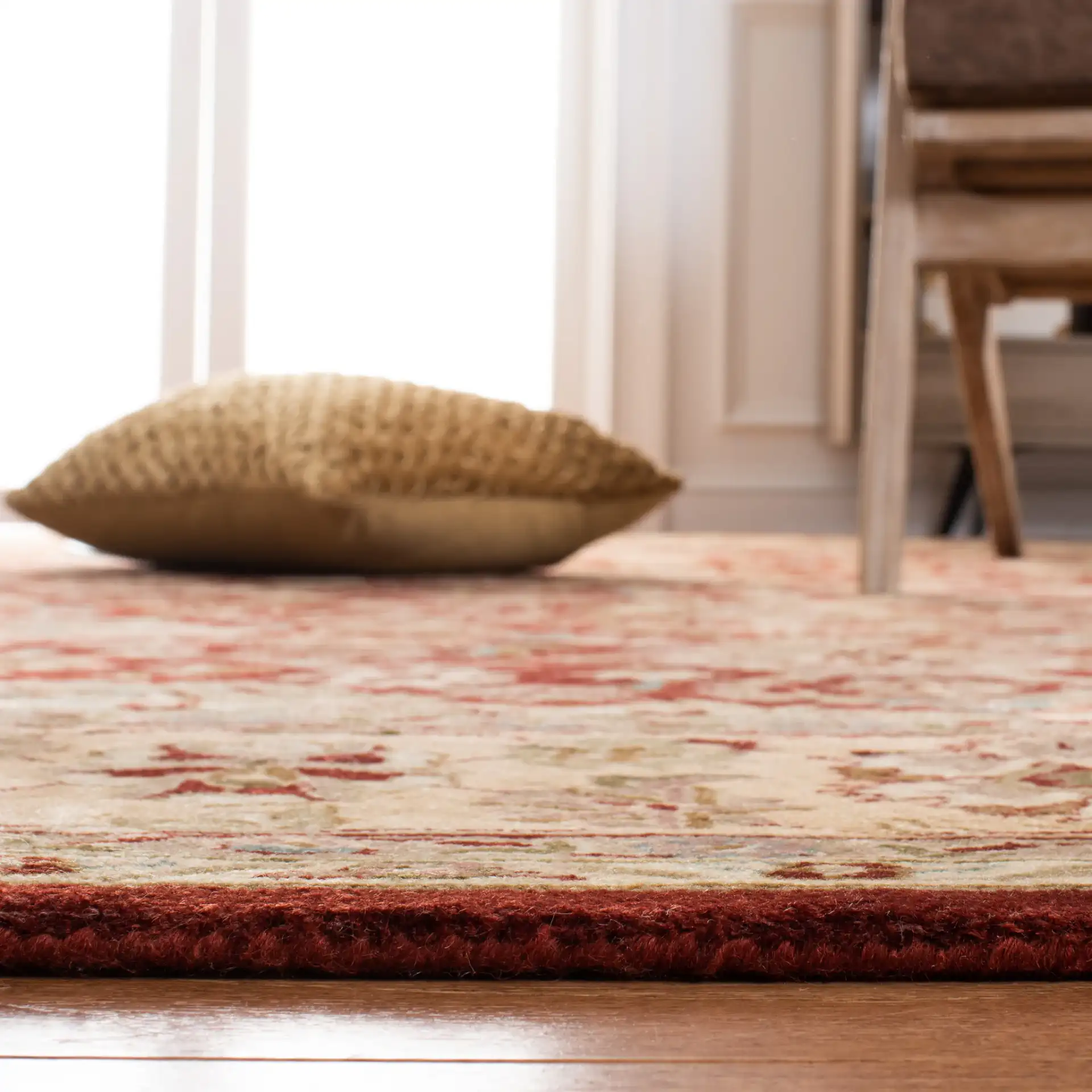 Persian Legend Floral Bordered Oval Wool Rug in Rust in a styled room