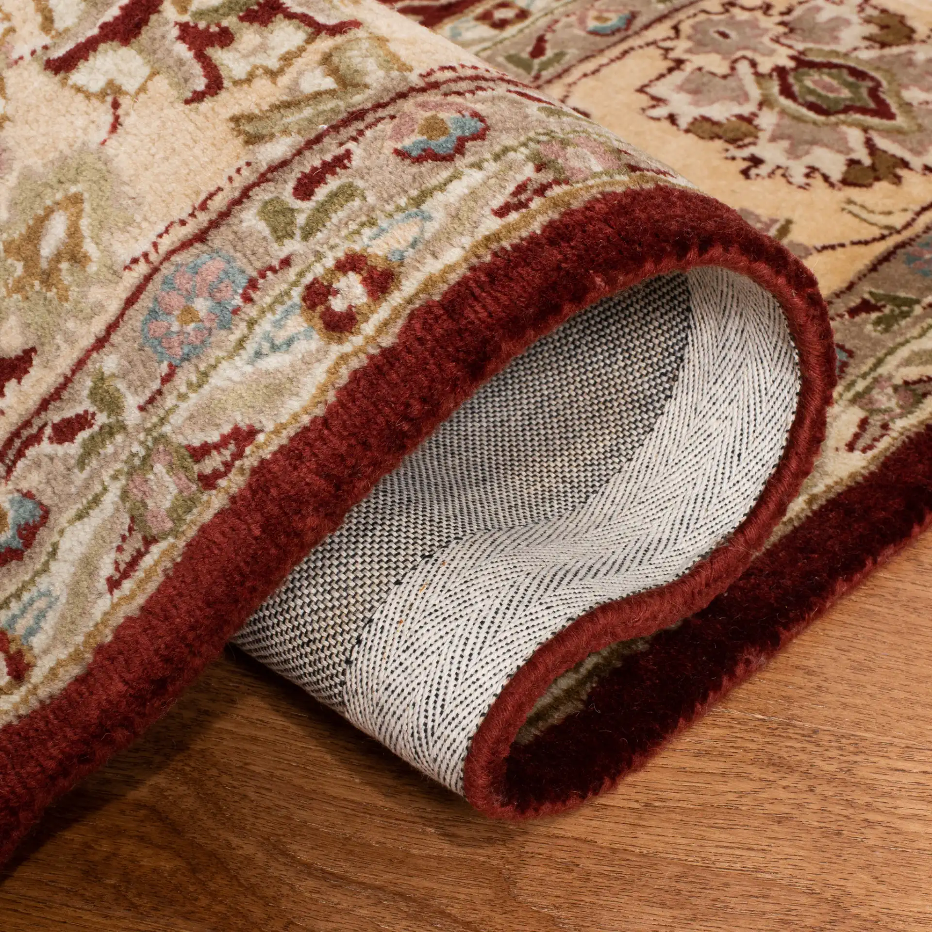 Persian Legend Floral Bordered Oval Wool Rug in Rust in a styled room