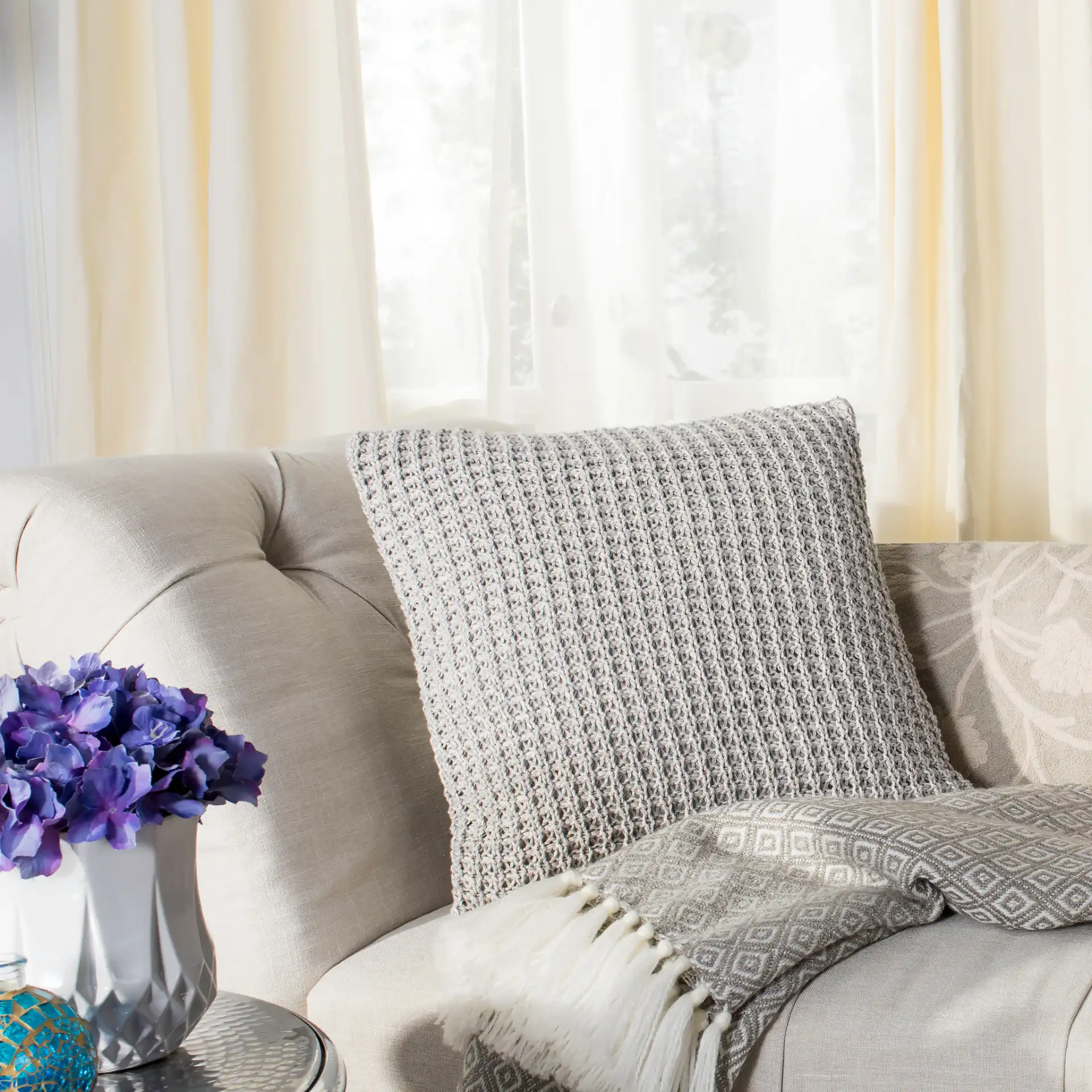 Haven Knit Pillow in Light Gray / Natural in a styled room
