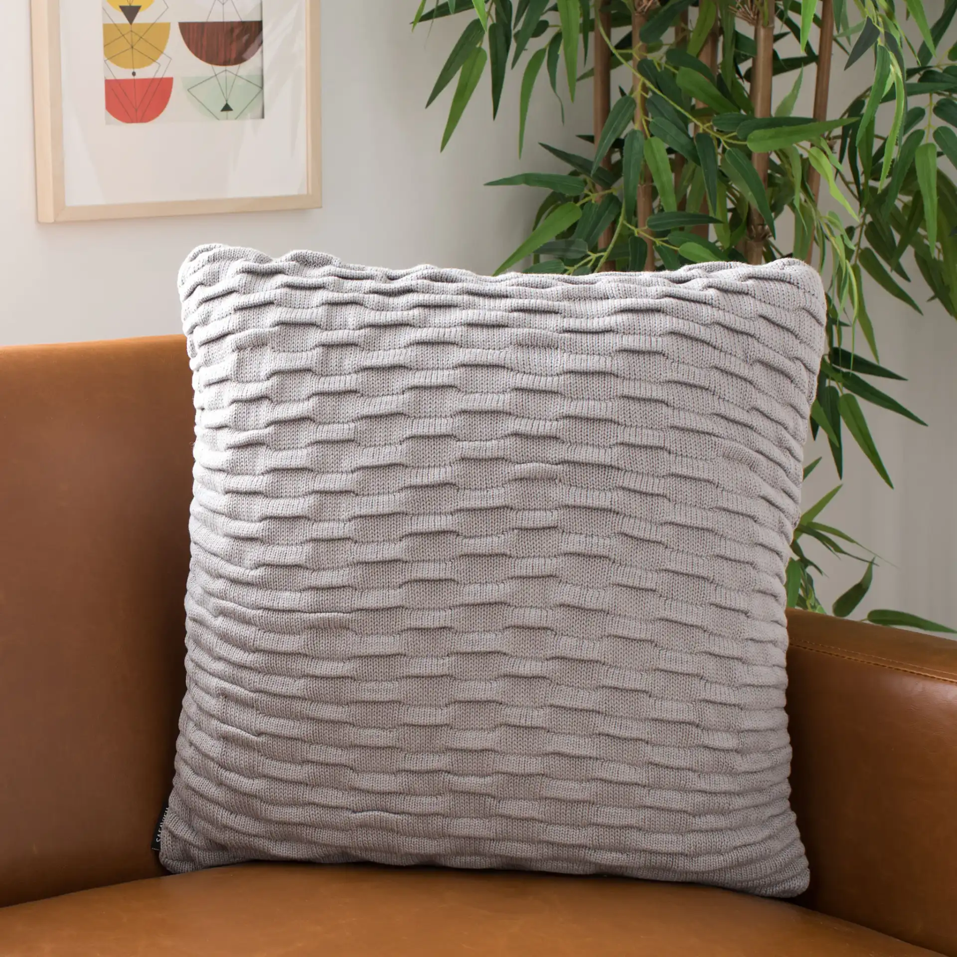Noela Knit Pillow in Light Gray in a styled room