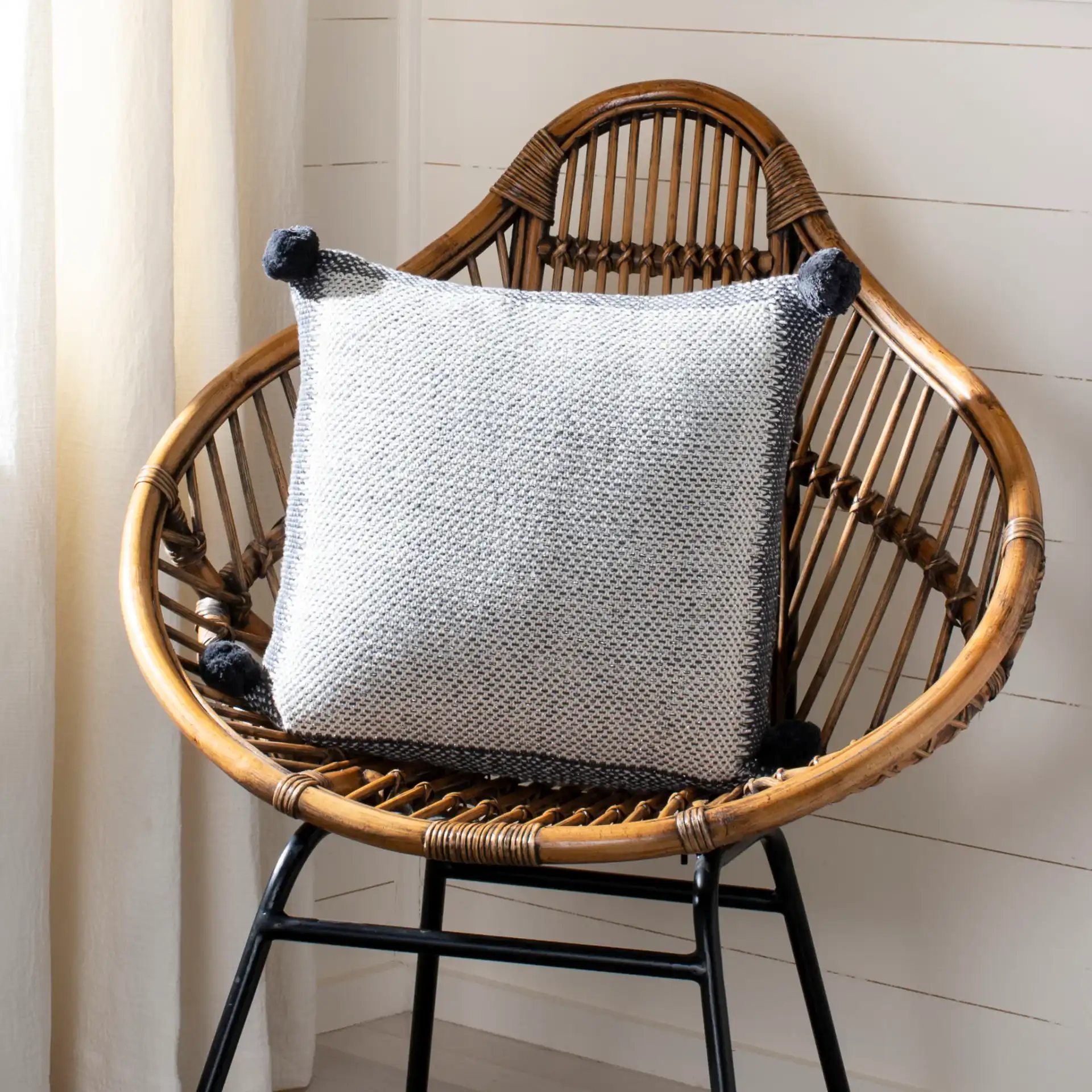 Dania Knit Pillow in Gray / Natural in a styled room