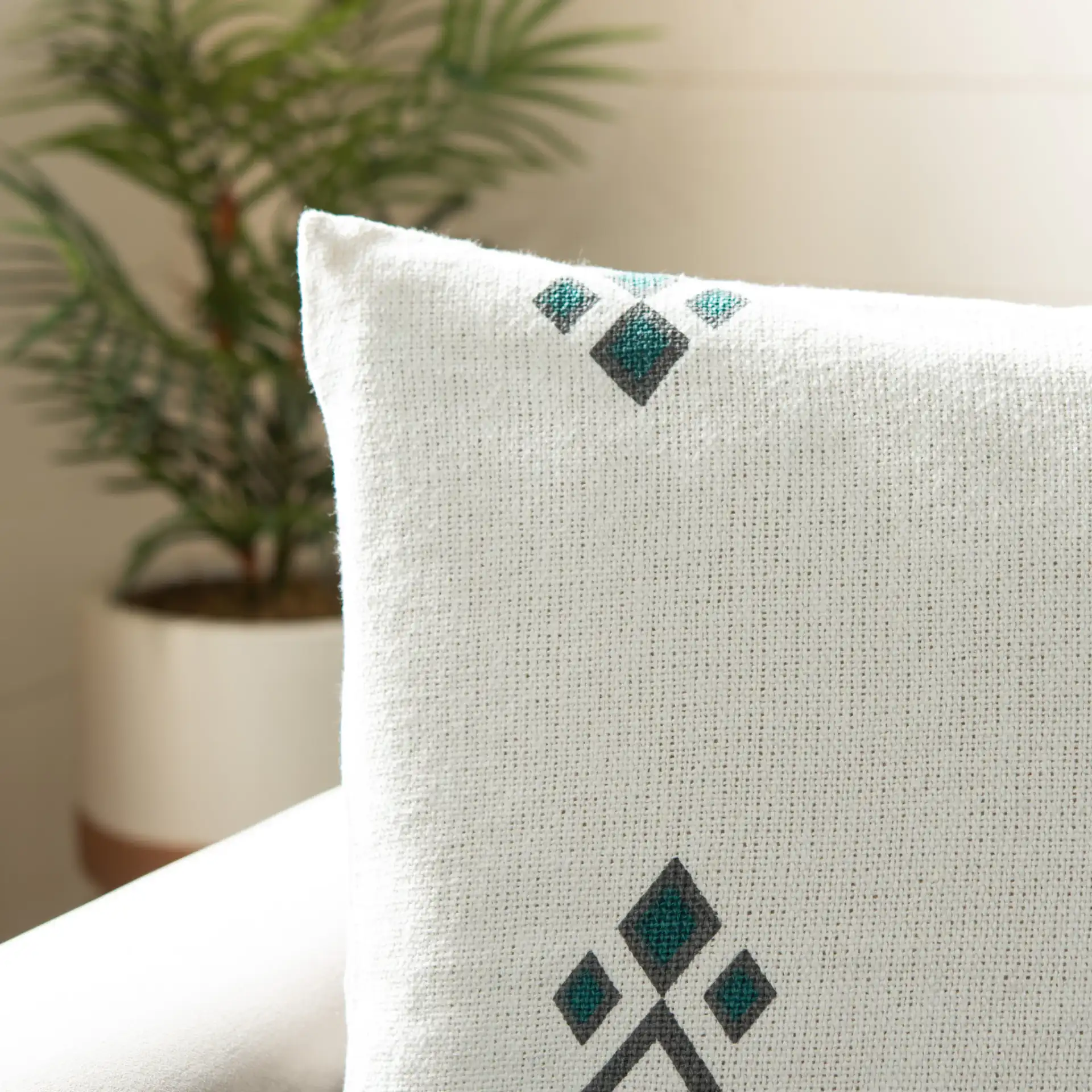 Lancia Pillow in Beige / Taupe / Turquoise in a styled room