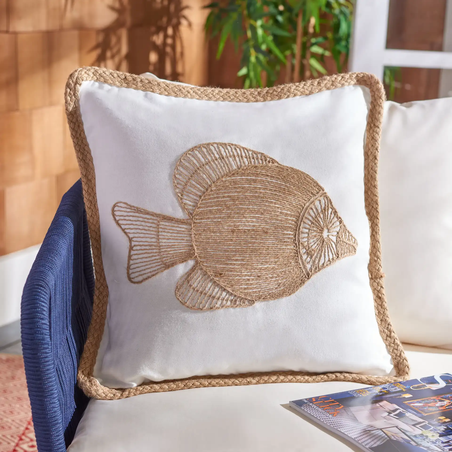 Nilam Fish Pillow in Natural in a styled room
