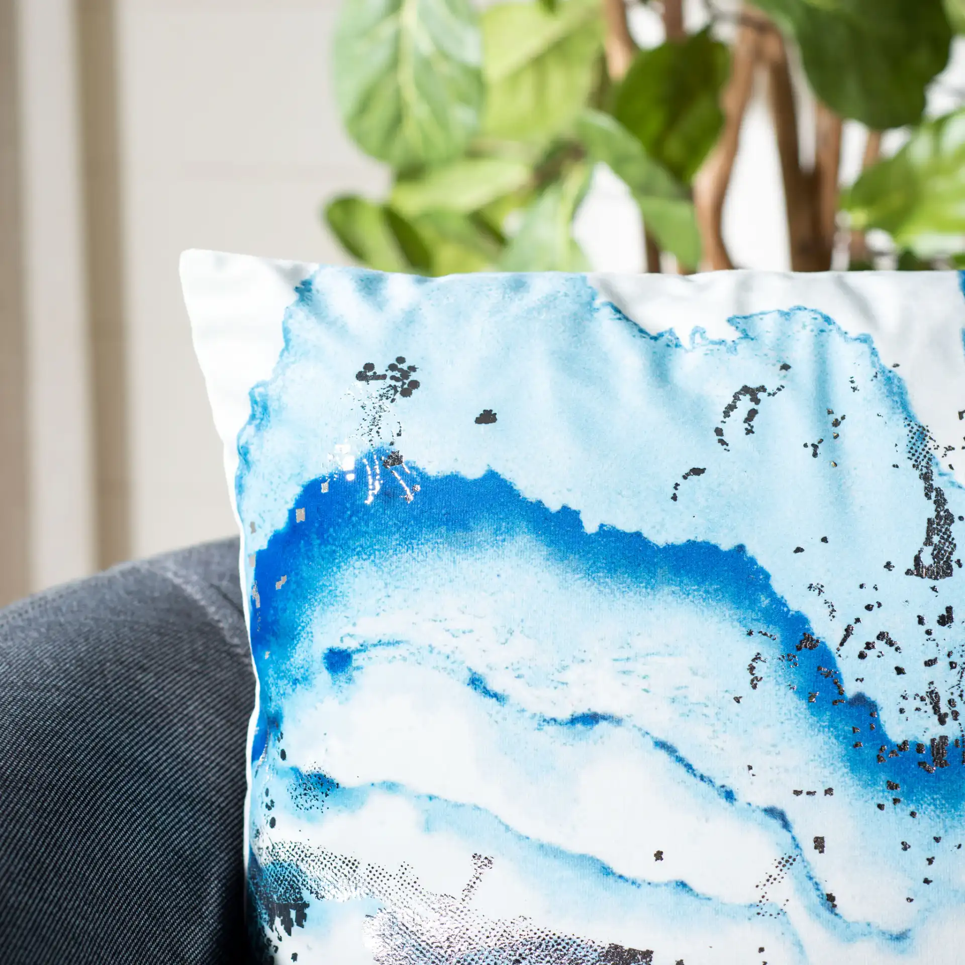 Jakki Pillow in White / Blue in a styled room