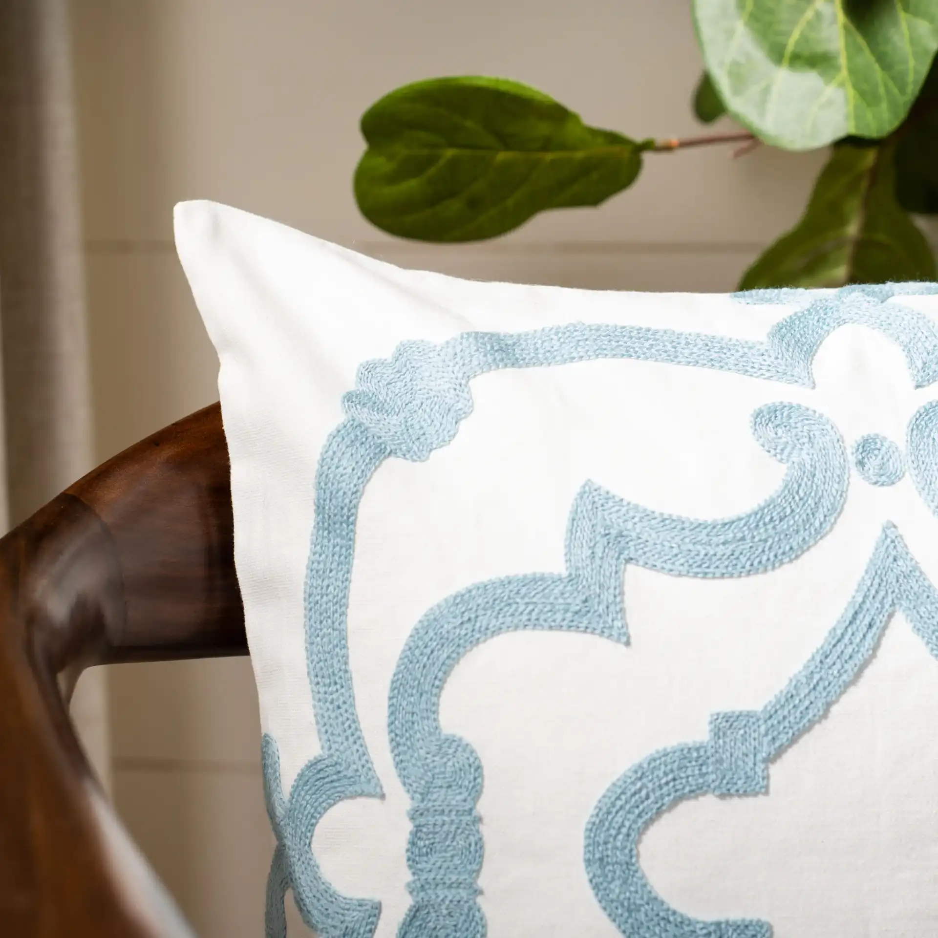 Daciana Pillow in White / Blue in a styled room