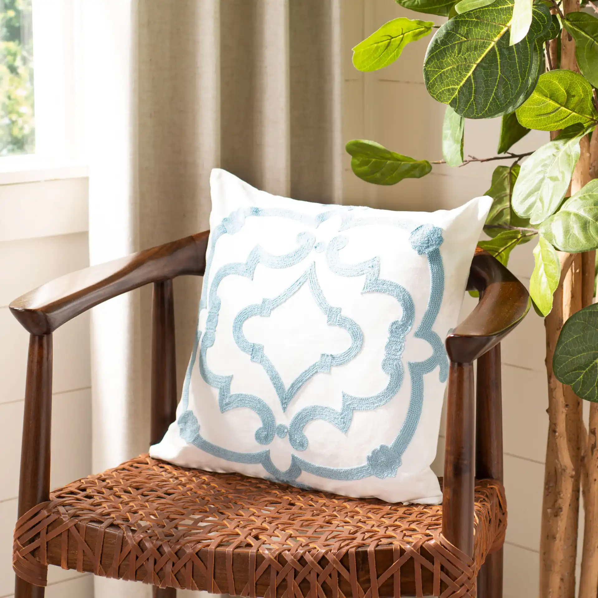 Daciana Pillow in White / Blue in a styled room