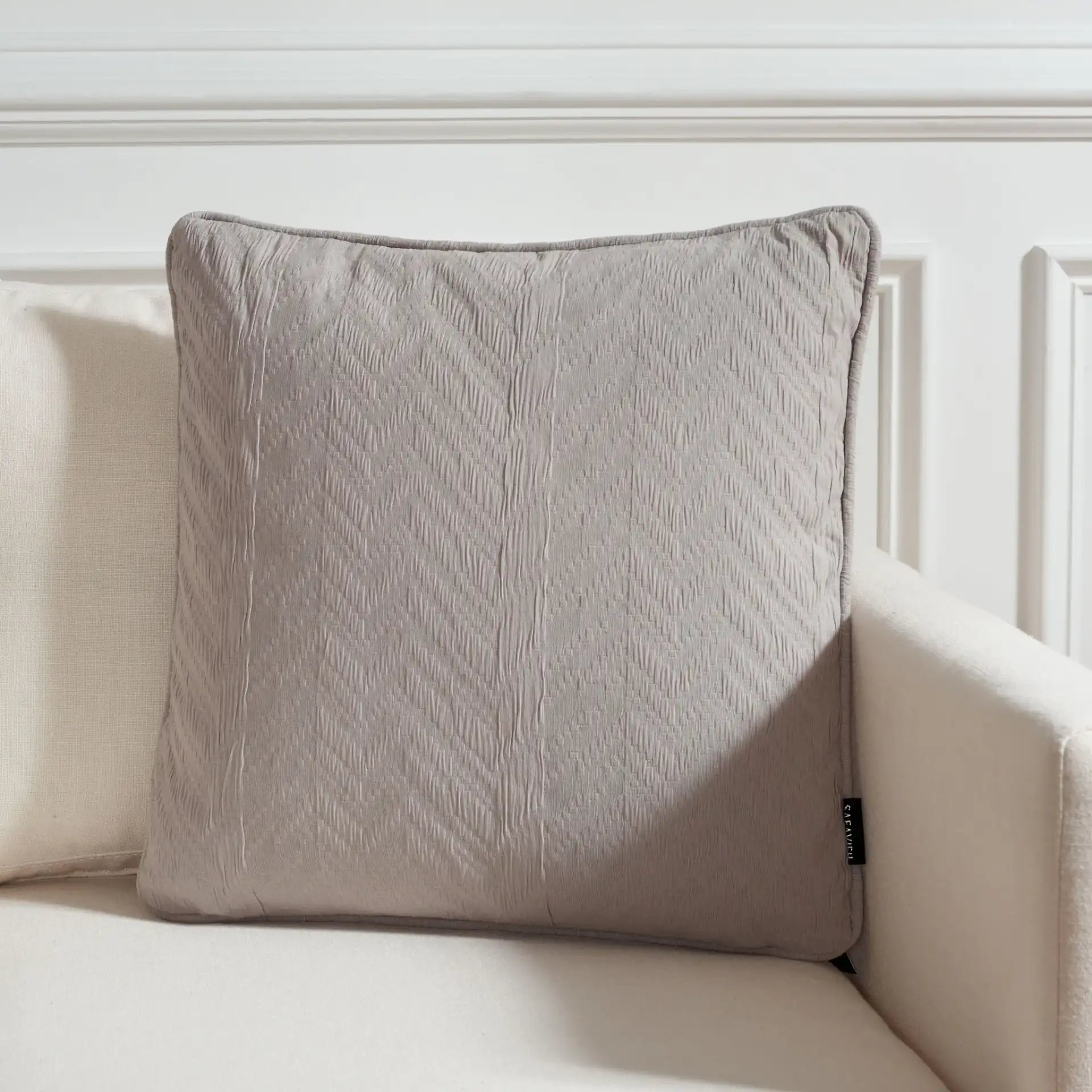 Faina Pillow in Gray in a styled room