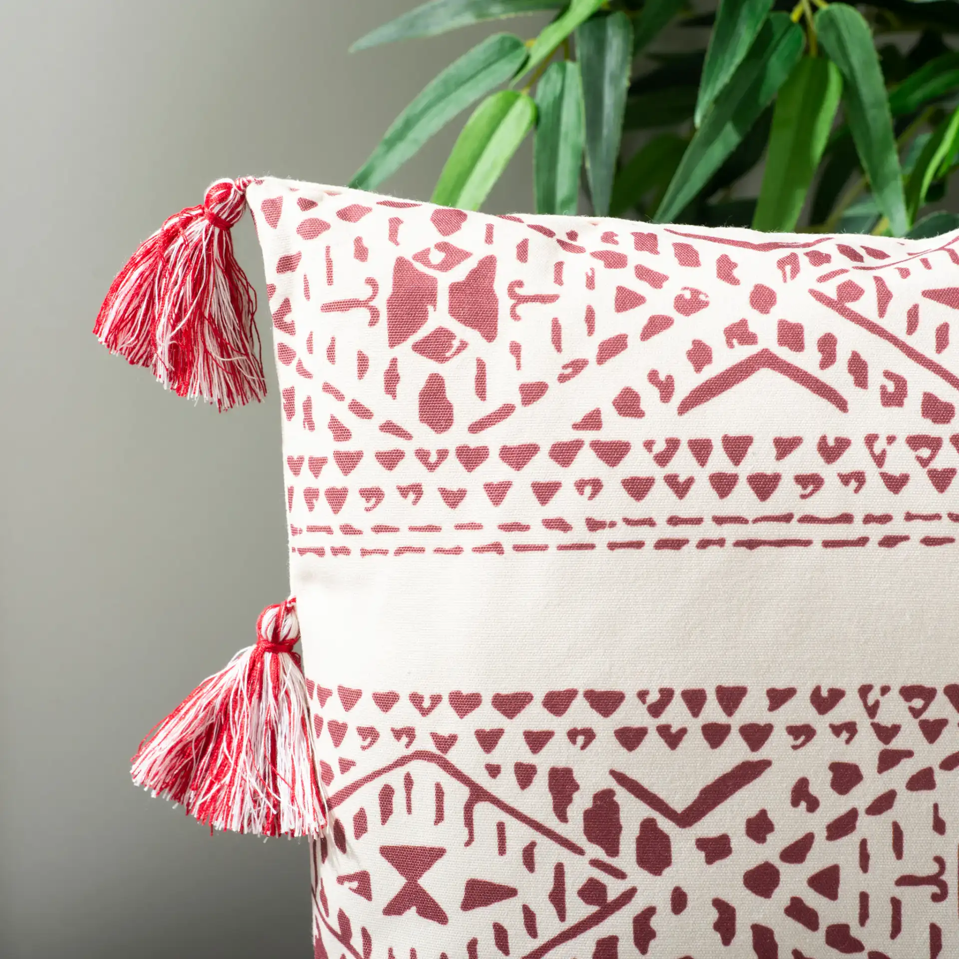 Landria Pillow in Beige / Red in a styled room