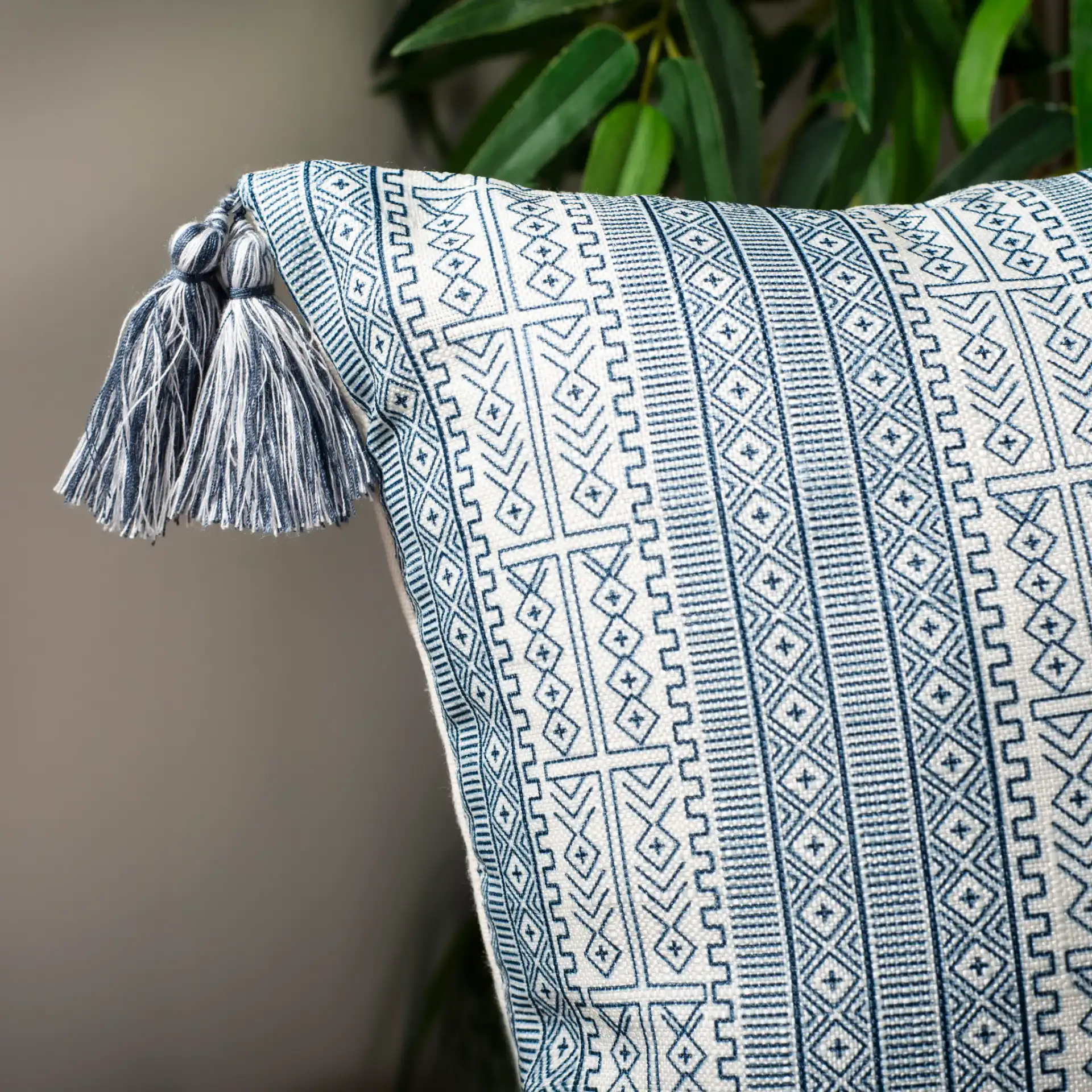 Lunette Pillow in White / Blue in a styled room