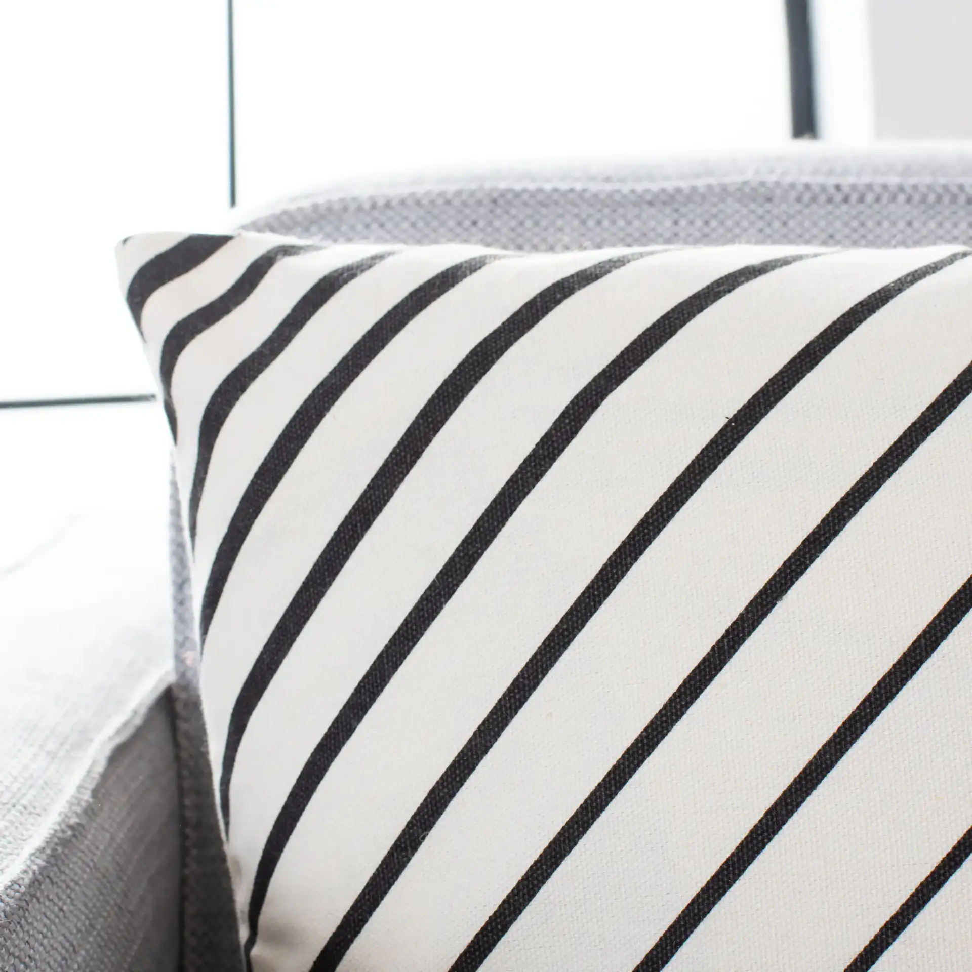 Trini Pillow in Brown / White in a styled room