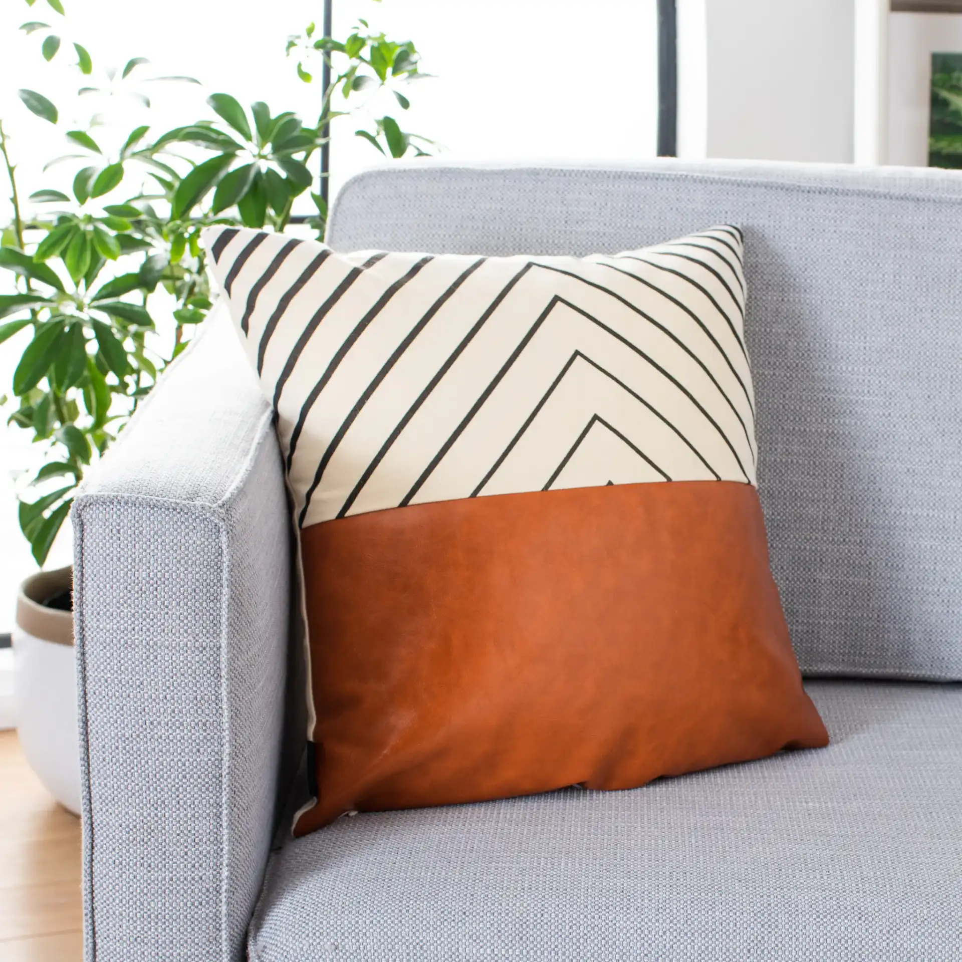 Trini Pillow in Brown / White in a styled room