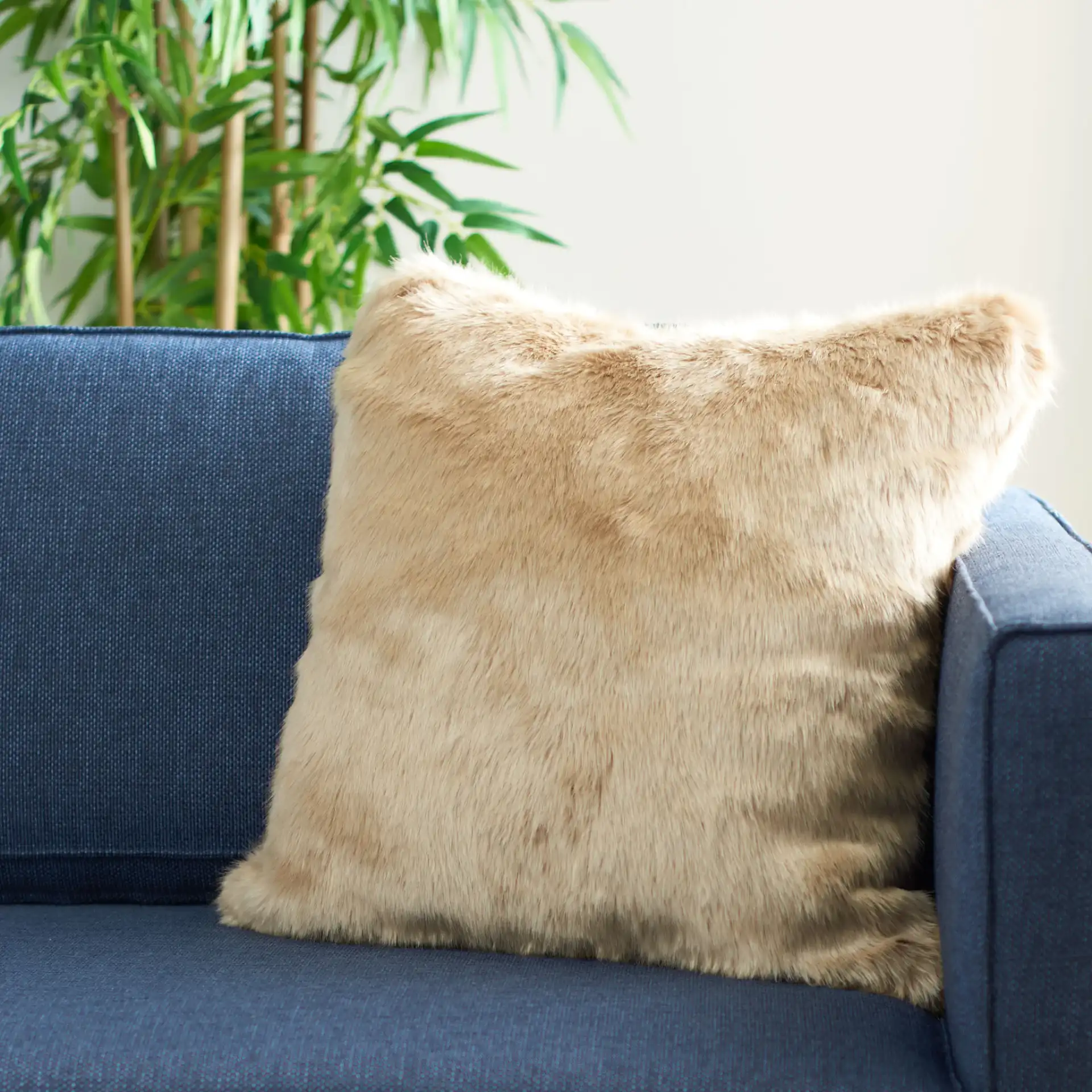 Adanna Fur Pillow in Brown in a styled room