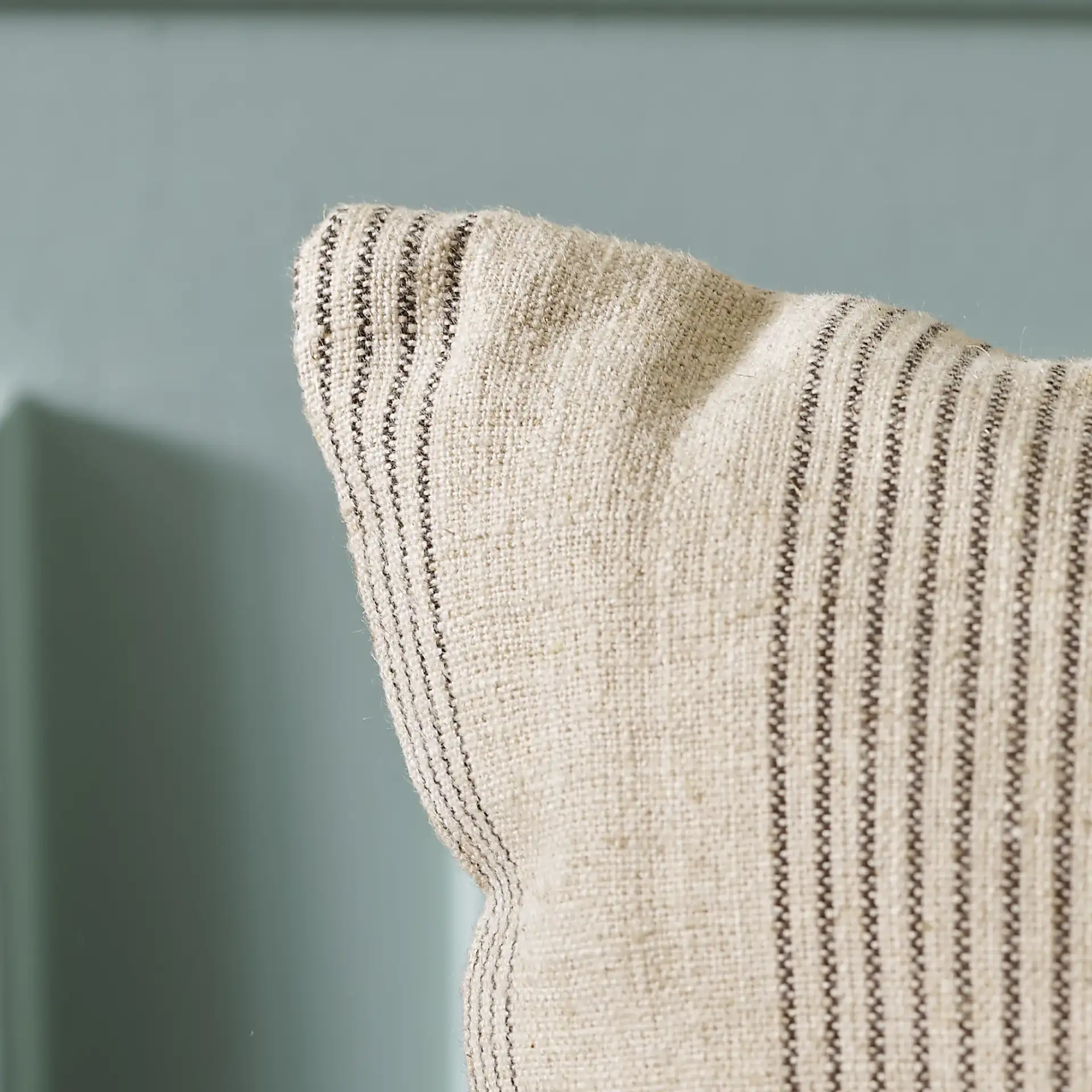 Mickey Linen Blend Pillow in Gray / Taupe in a styled room