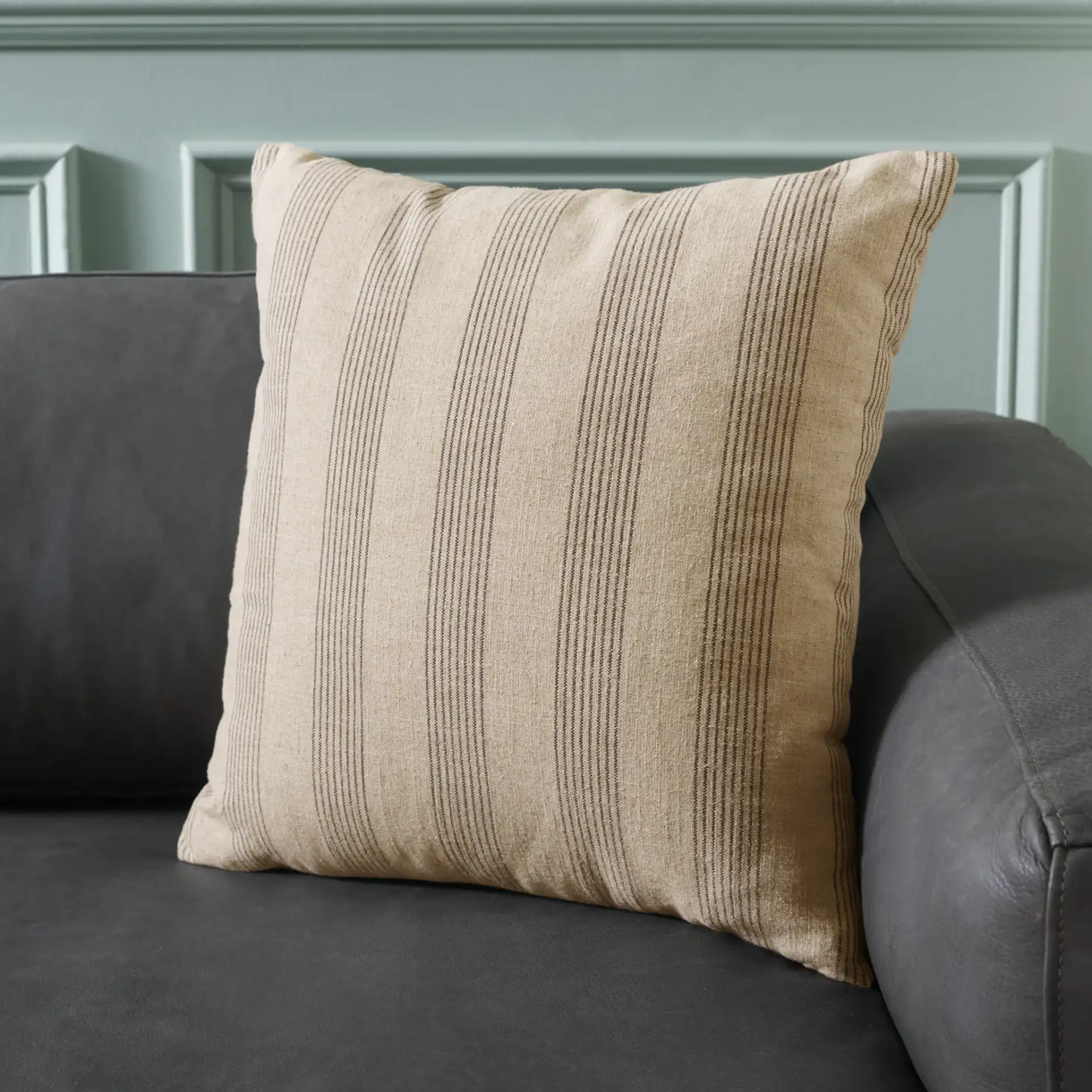 Mickey Linen Blend Pillow in Gray / Taupe in a styled room