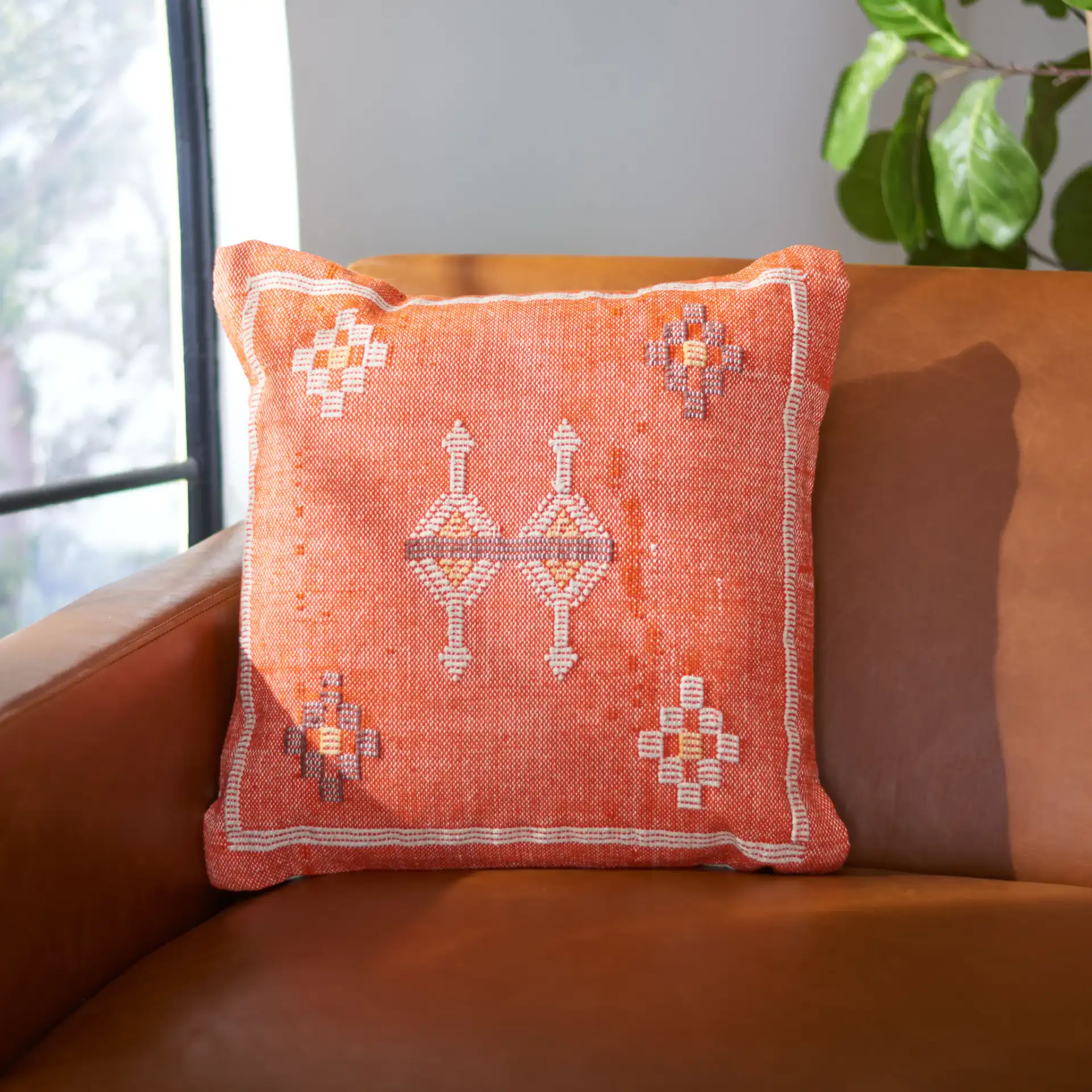 Pyrra Pillow in Orange in a styled room