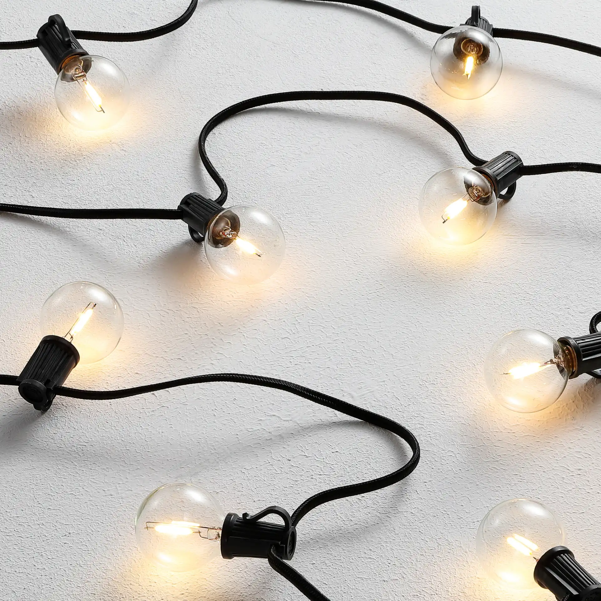Leigh Outdoor String Light in Black in a styled room