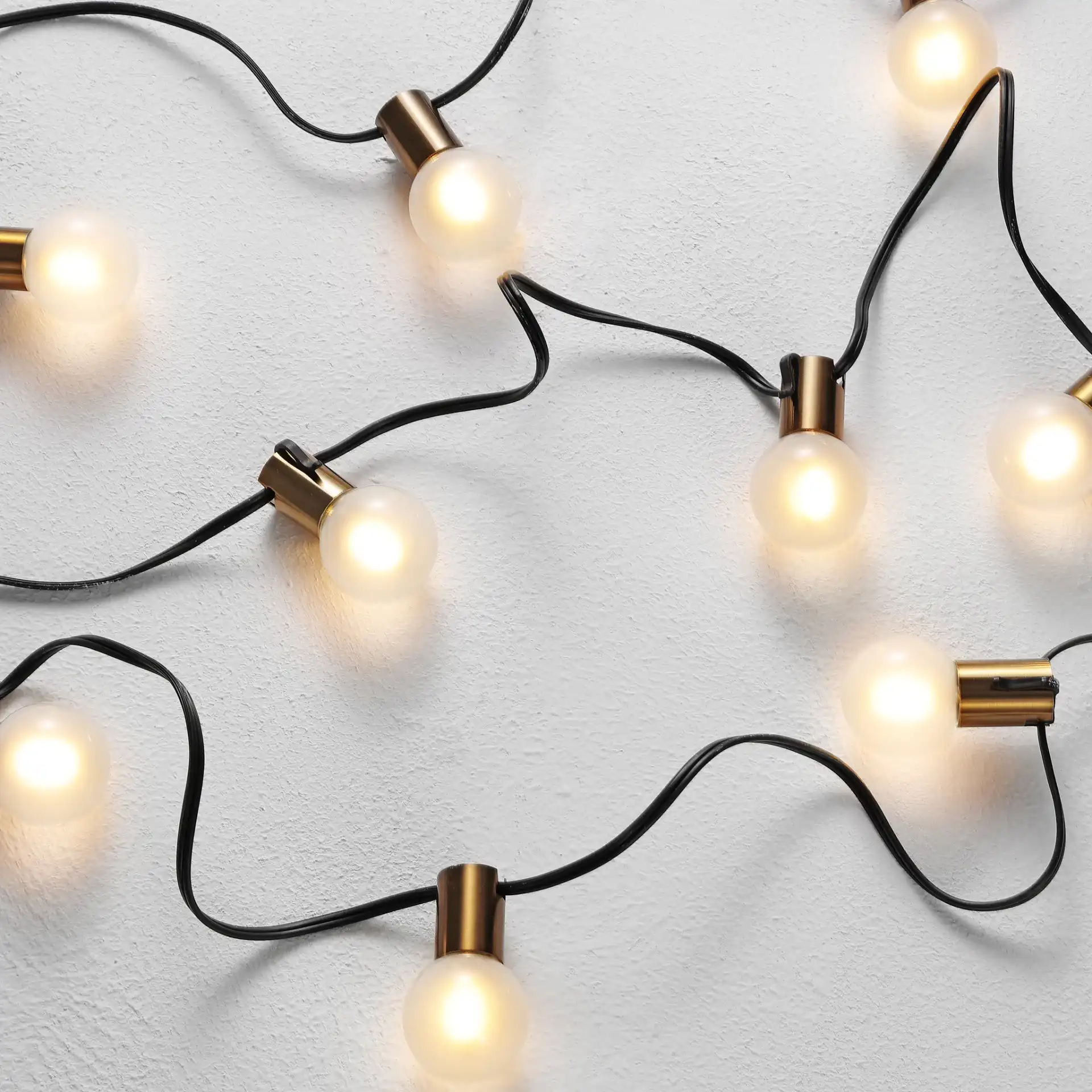 Farrynn Outdoor String Lights in Brass / Black in a styled room