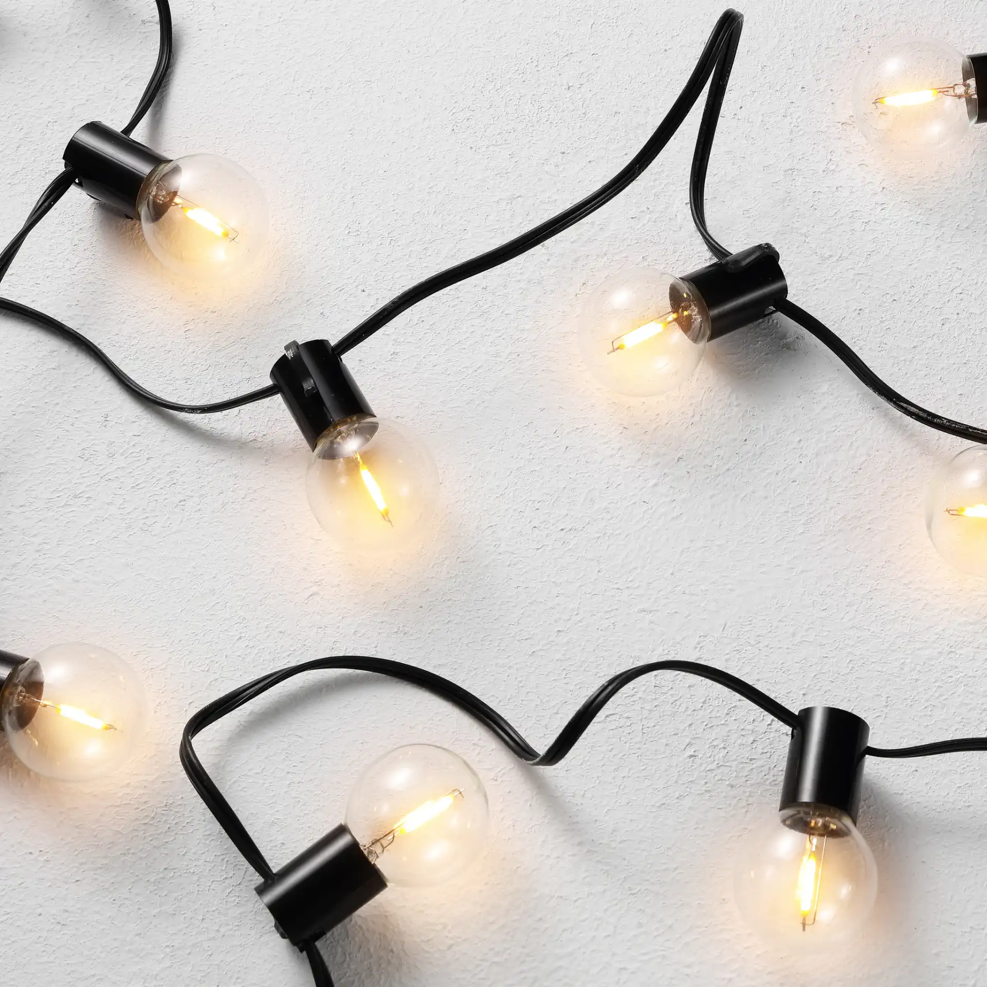 Huron Led Outdoor String Light in Black in a styled room