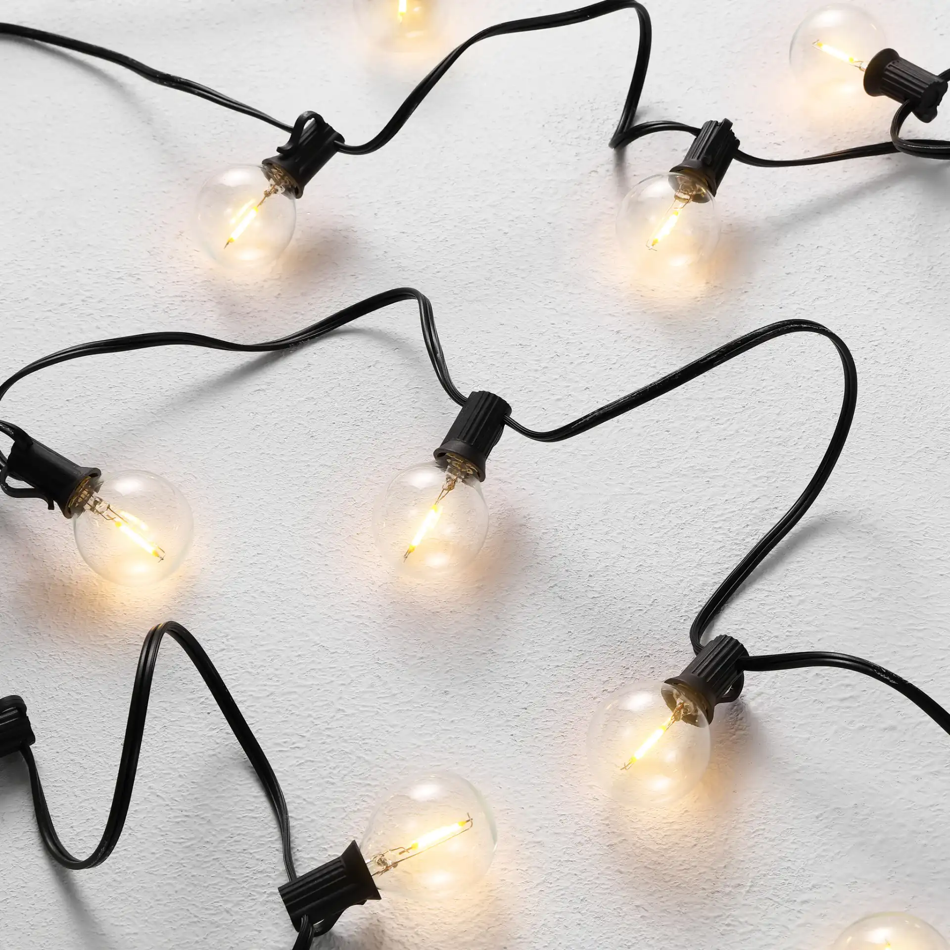 Jenica Outdoor String Lights in Black in a styled room