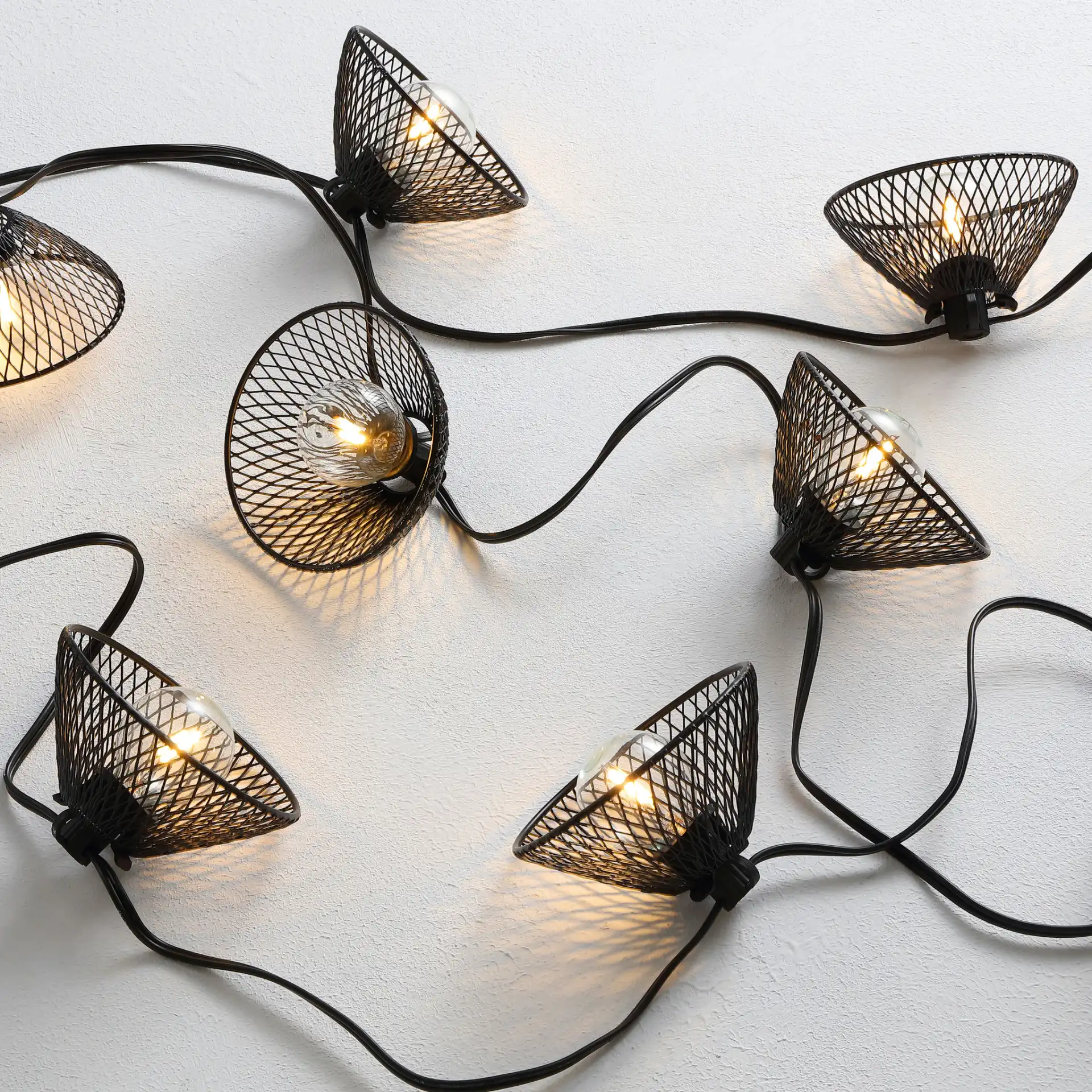Junia Led Outdoor String Light in Black in a styled room
