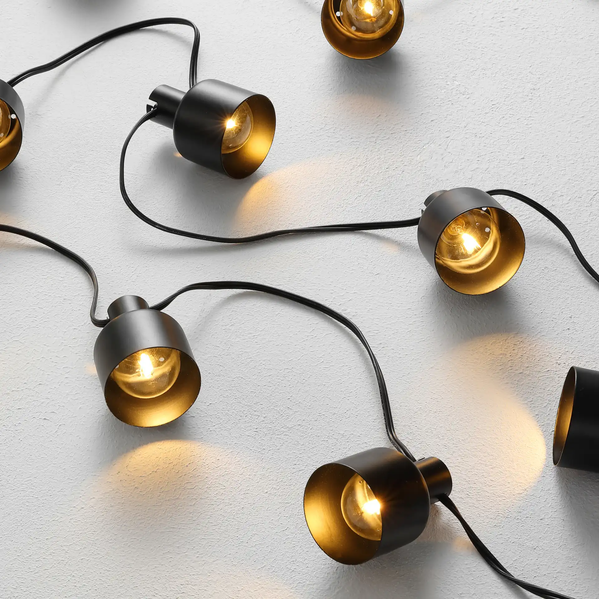 Adaner Led Outdoor String Lights in Black in a styled room