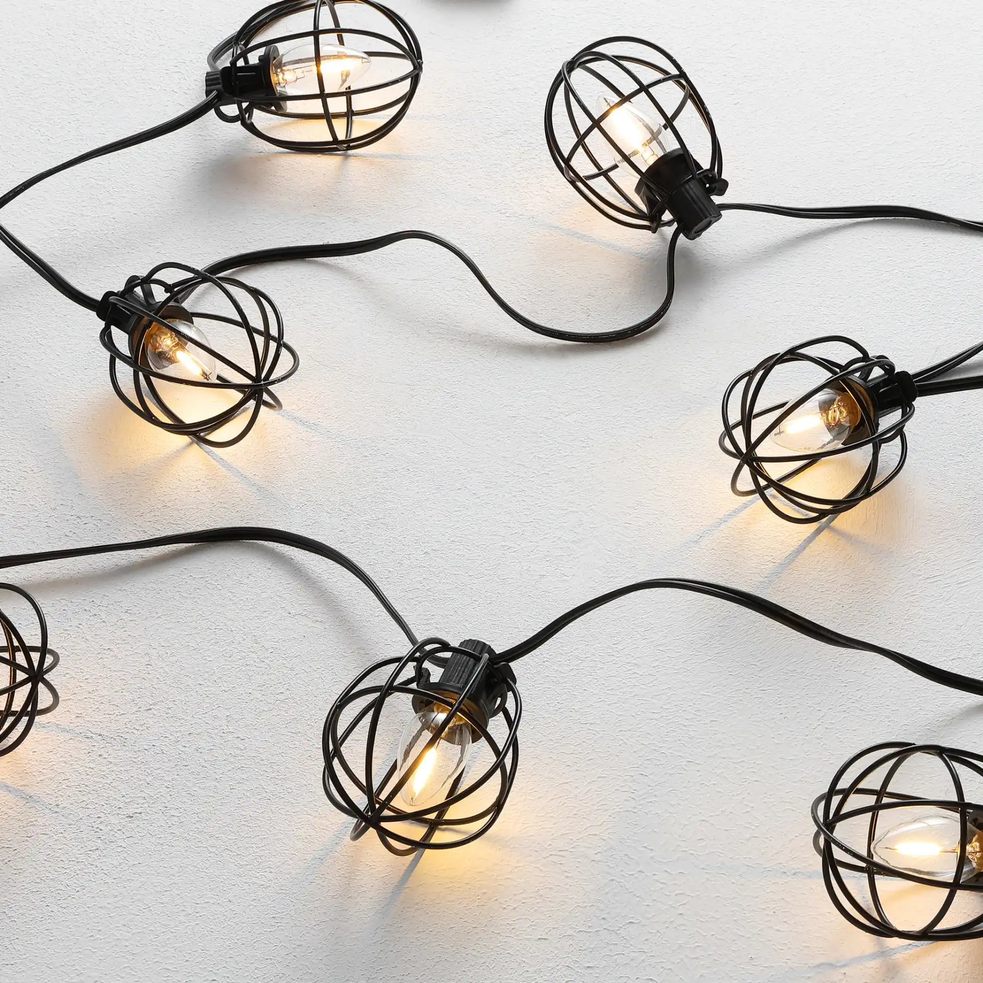 Garnet Led Outdoor String Light in Black in a styled room