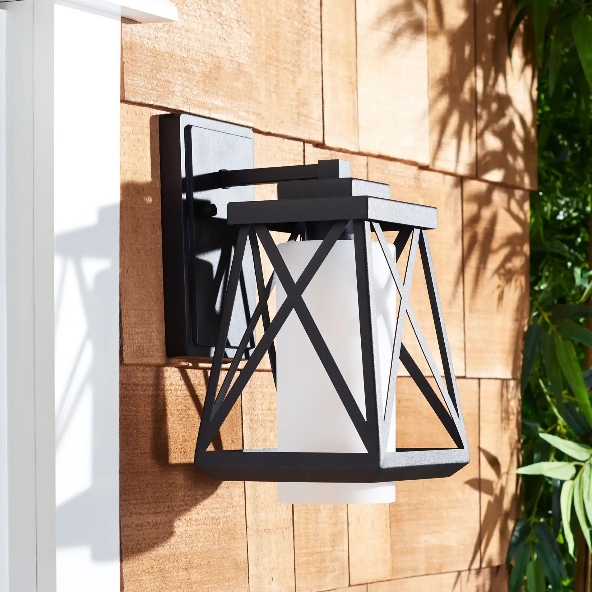 Braith Outdoor Wall Sconce (Set of 2) in Black in a styled room